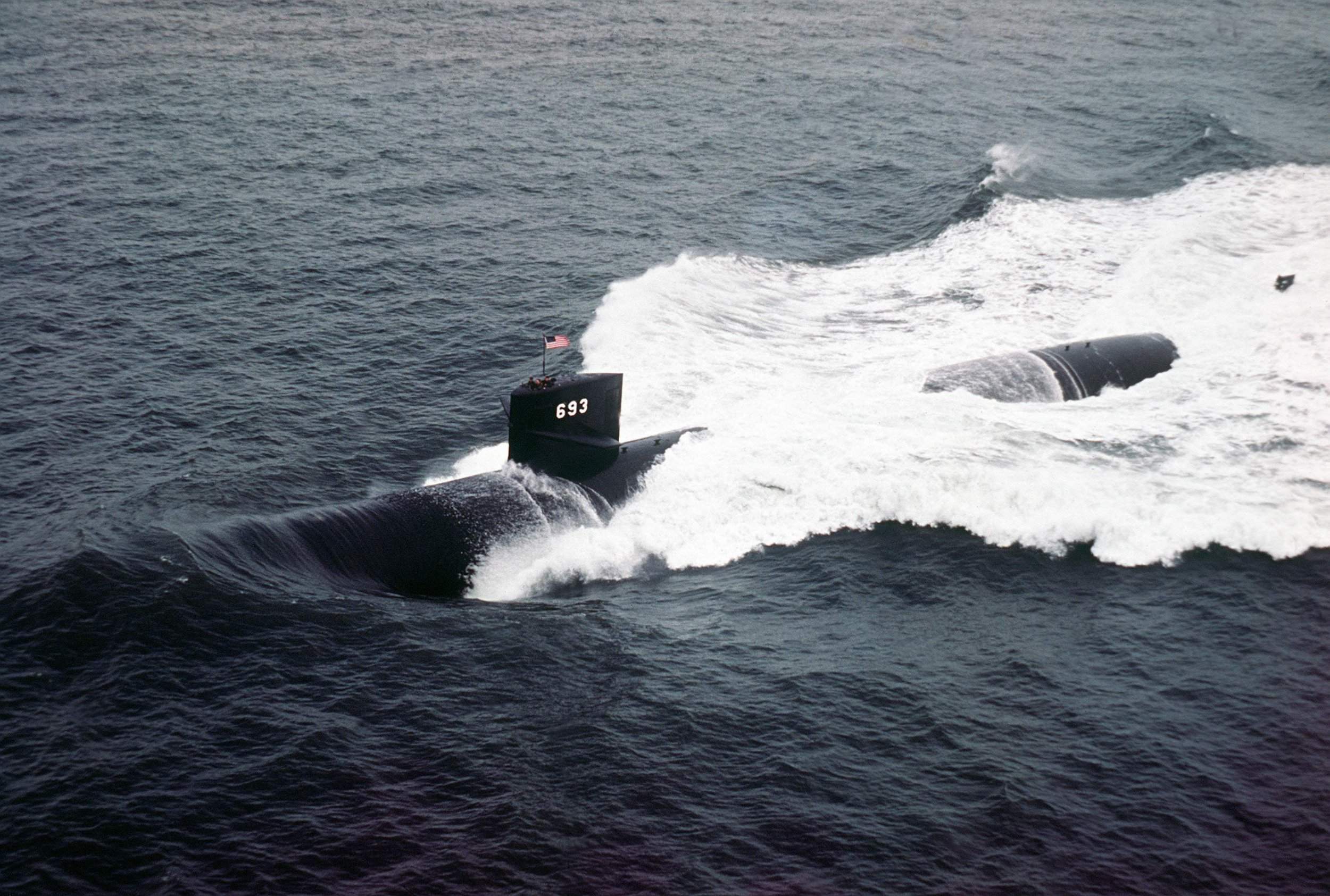 Nuclear attack submarine with hull number 693 underway at sea, viewed from above.