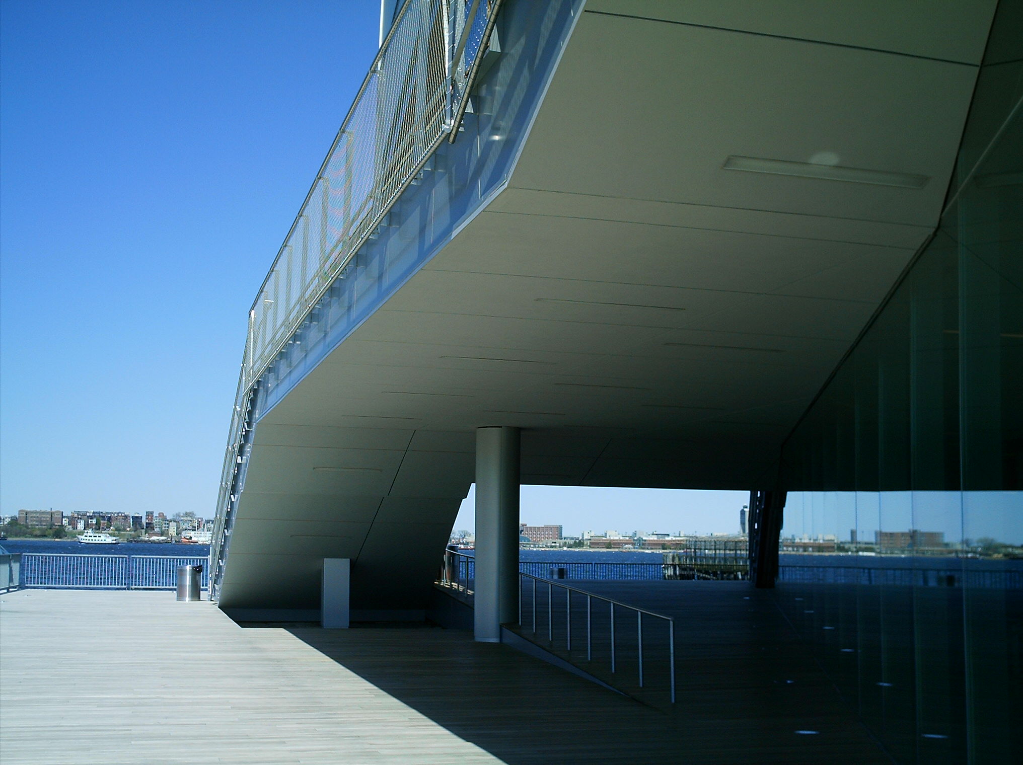 Cantilevered exterior overhang of ICA Boston with wooden deck and waterfront beyond.