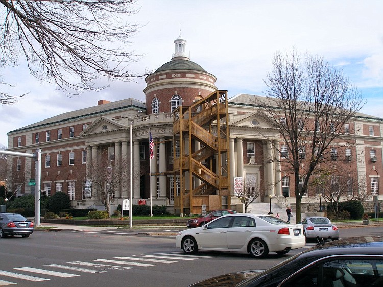 Neoclassical brick YMCA building with dome and columns in winter.