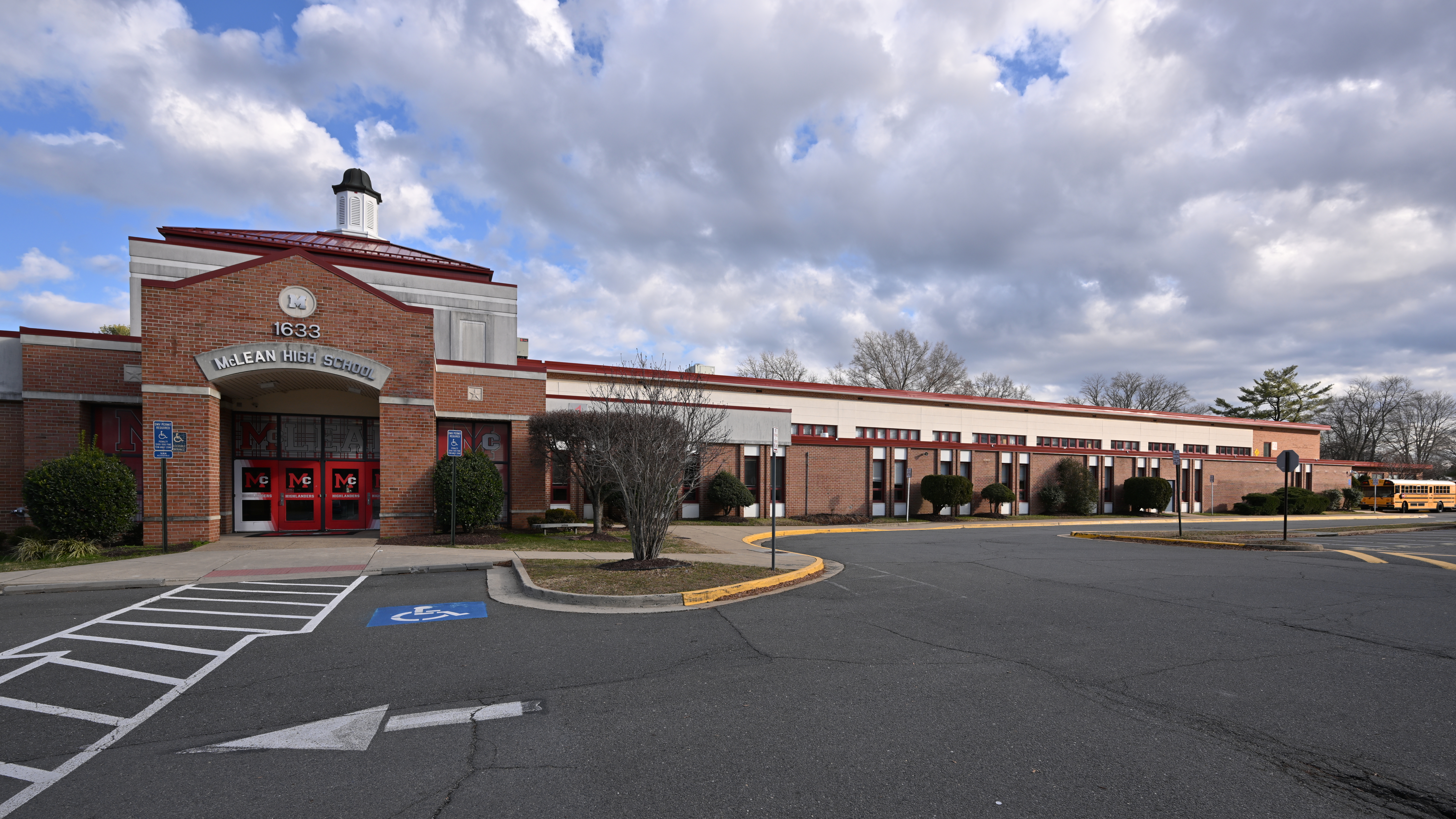 Wide view of the front facade of McLean High School, a large brick building.