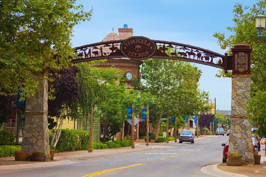 Decorative arch spanning a tree-lined street at the entrance to Old Town Temecula.