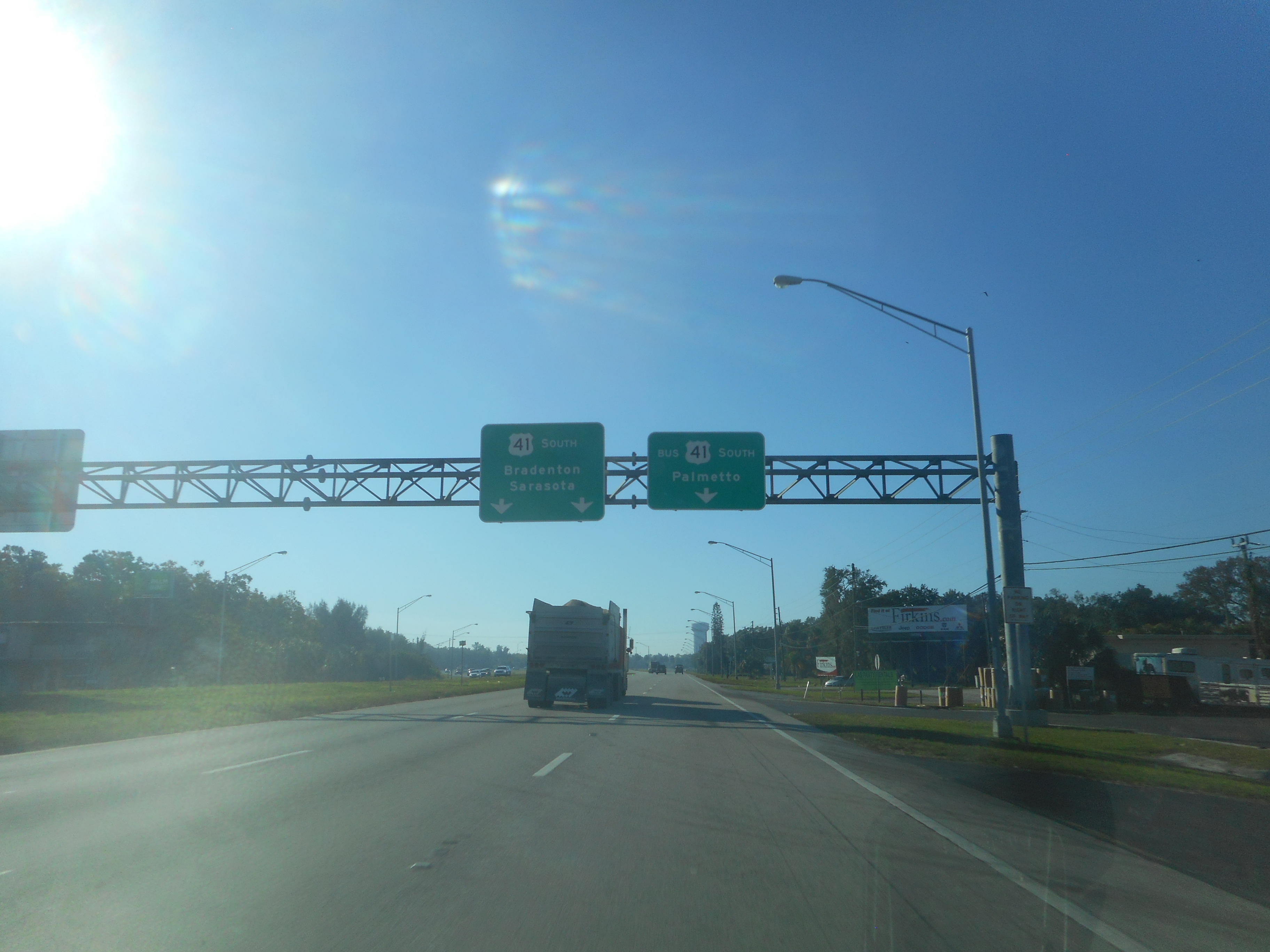 Southbound multi-lane highway with overhead green directional signs toward Bradenton and Sarasota.