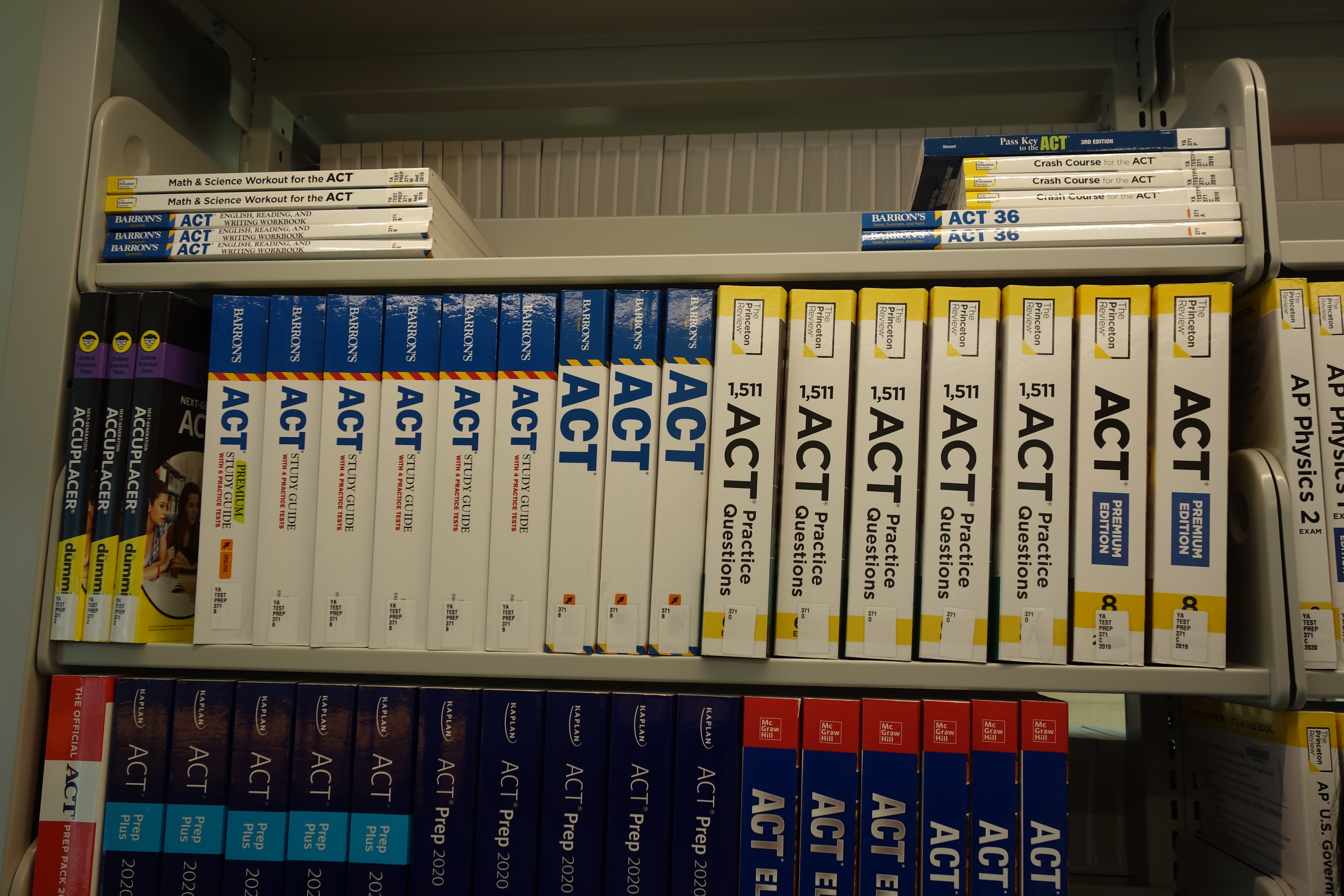 Shelves of standardized test preparation books in a library.