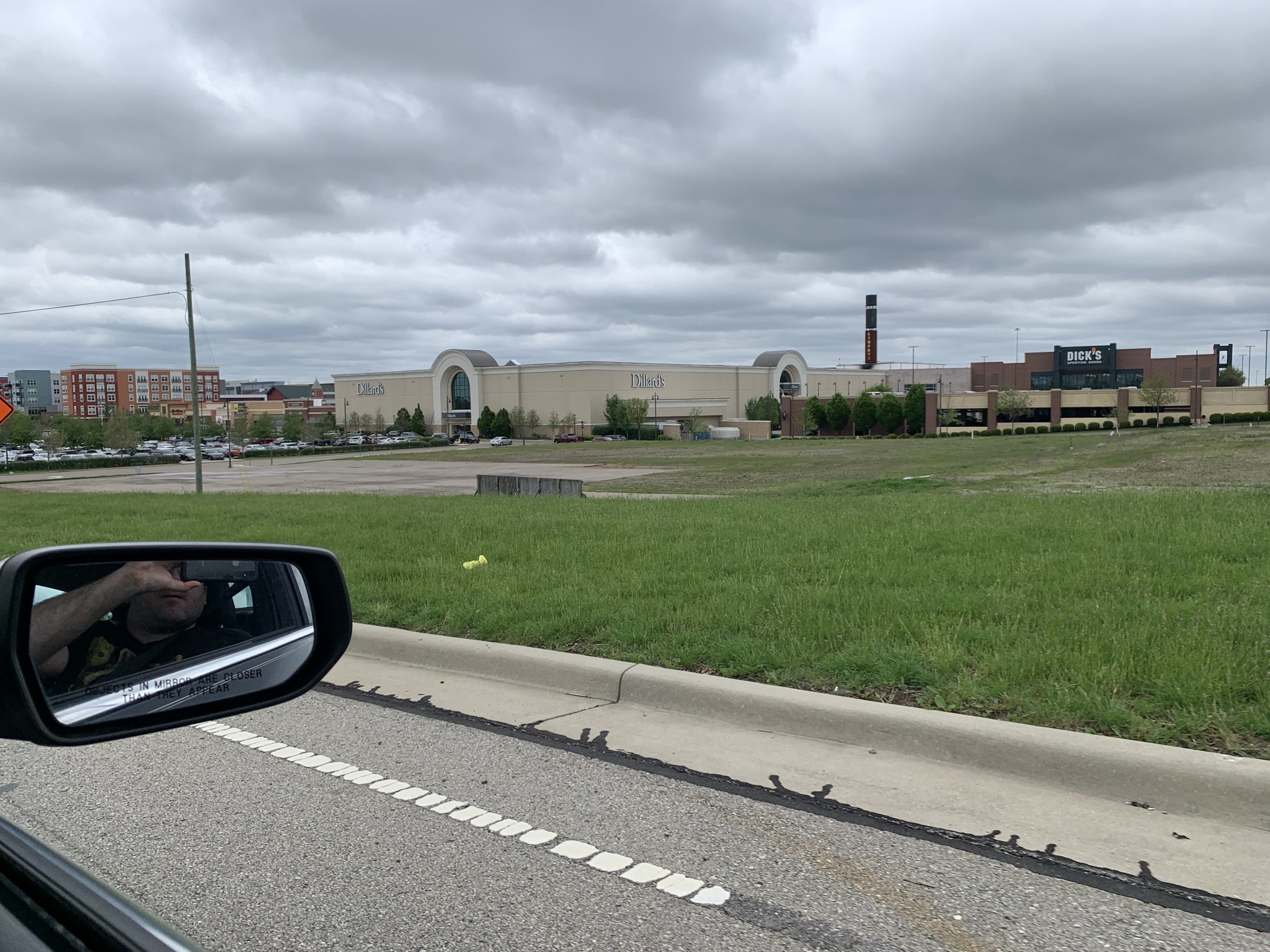 Liberty Center shopping mall exterior with arched facade and parking lot under overcast sky.