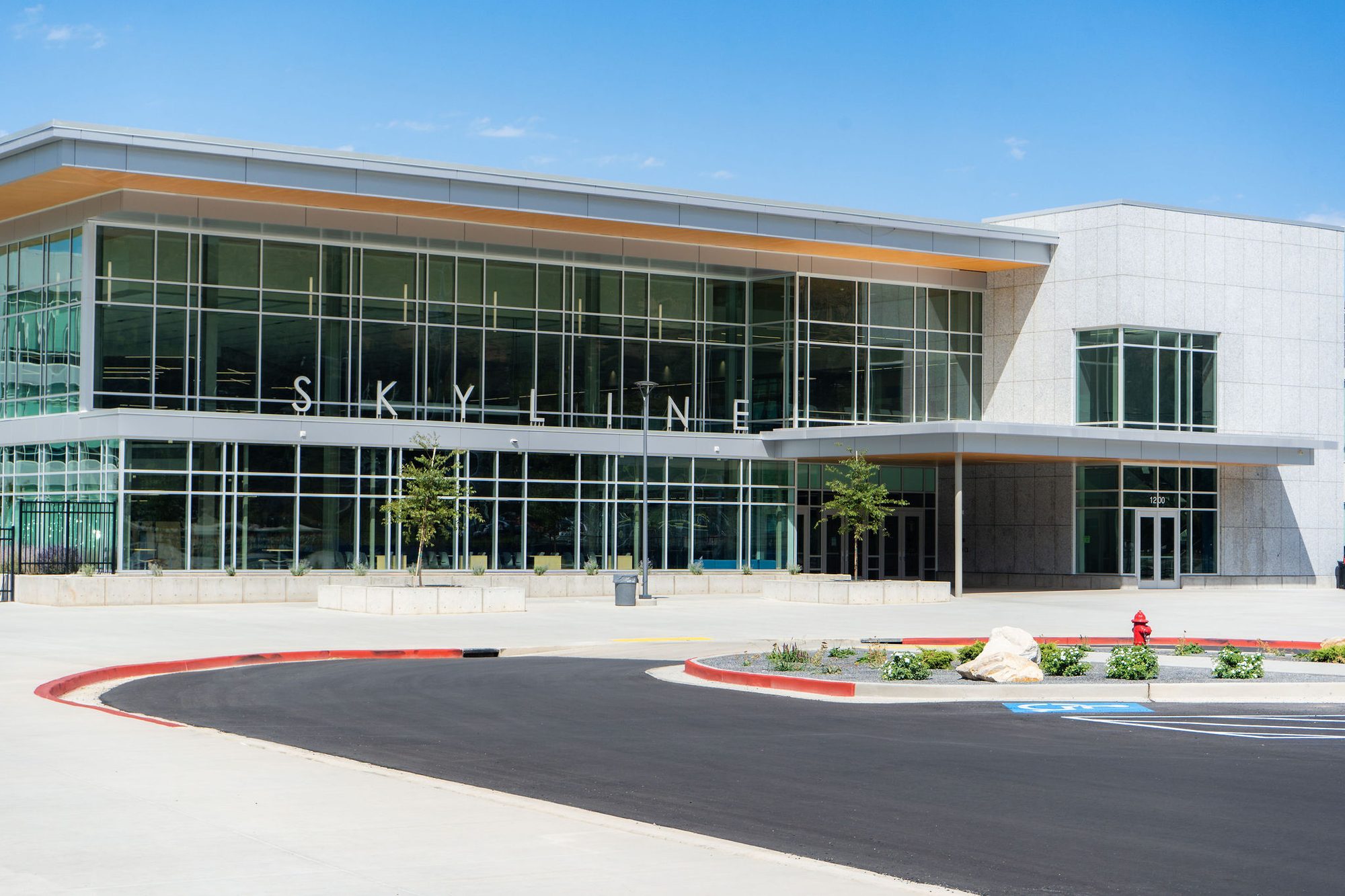Modern glass-fronted school building with large Skyline signage above the entrance.