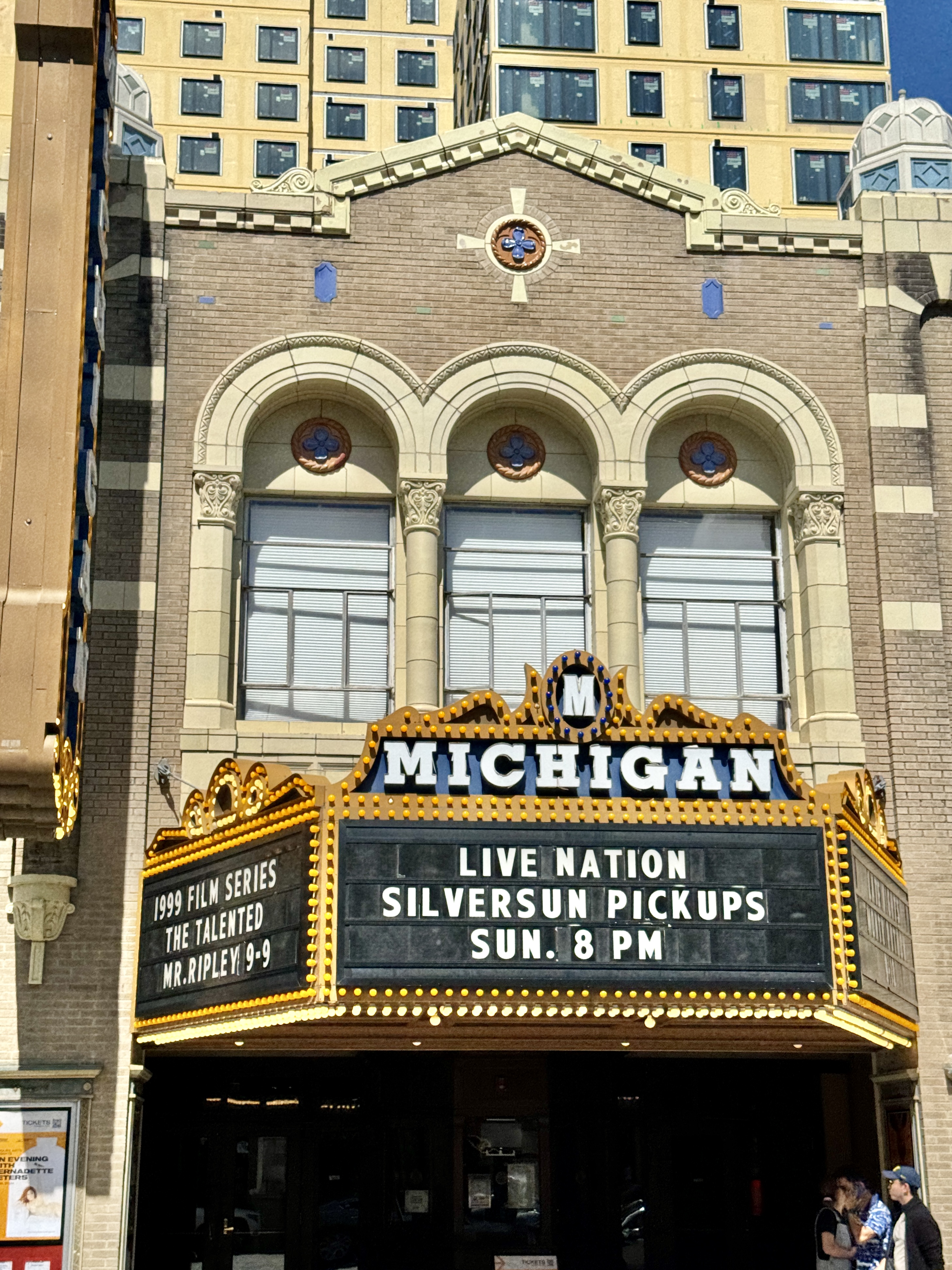 Close-up of the Michigan Theater facade showing marquee and ornate architectural details.