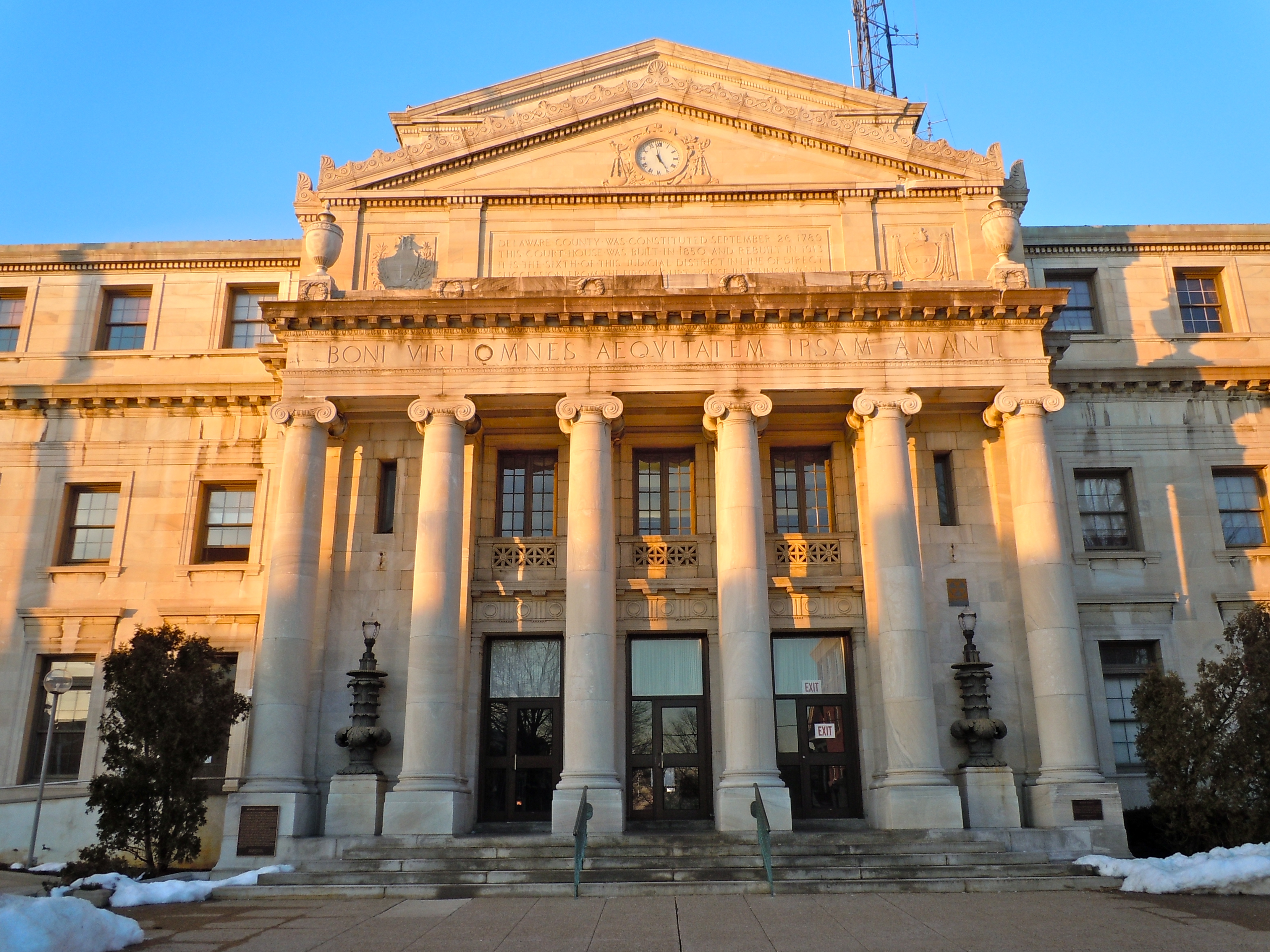 Neoclassical courthouse with large Ionic columns and a clock in the pediment.