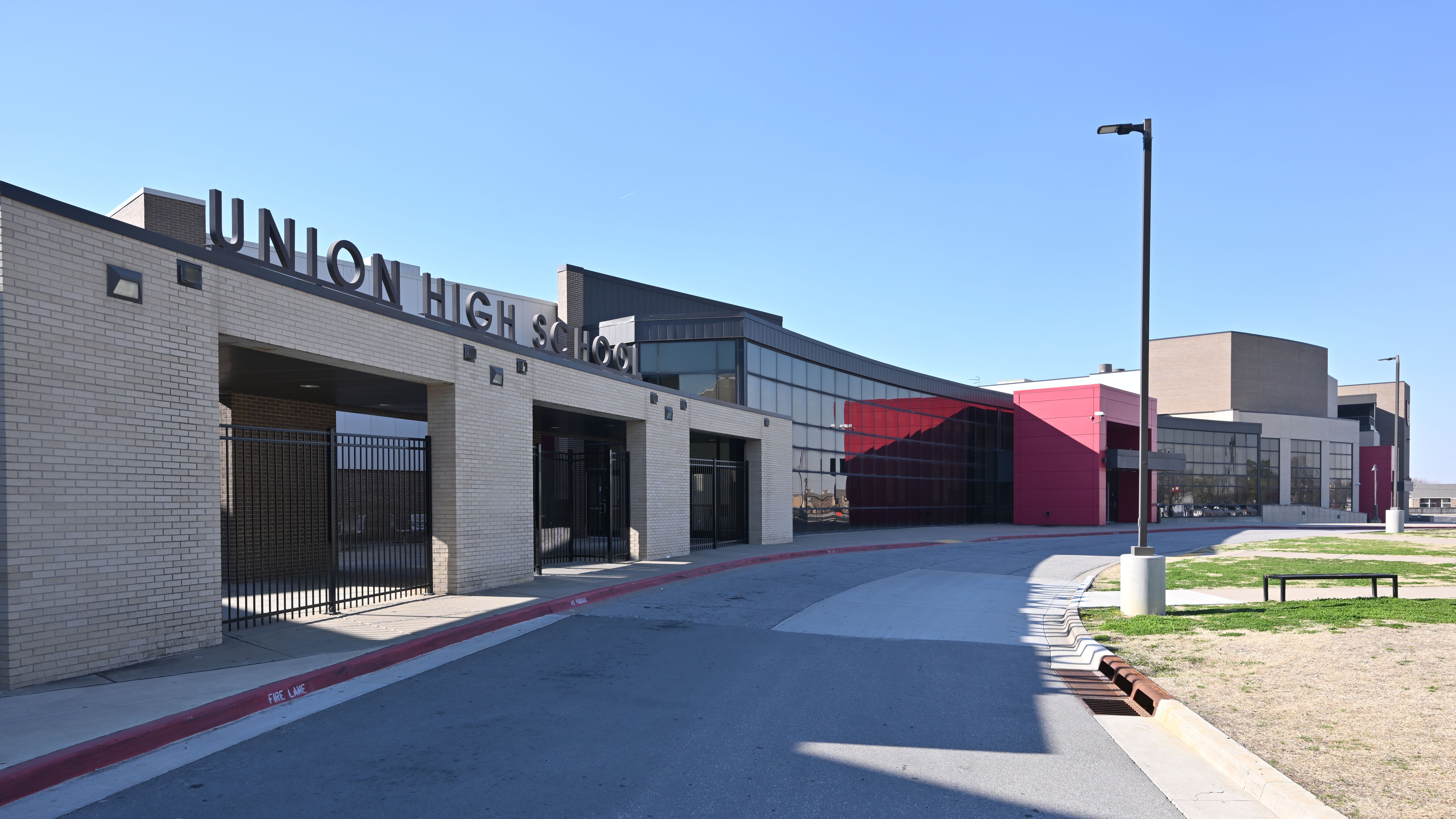 Exterior of Union High School, a modern brick and glass building under a clear blue sky.