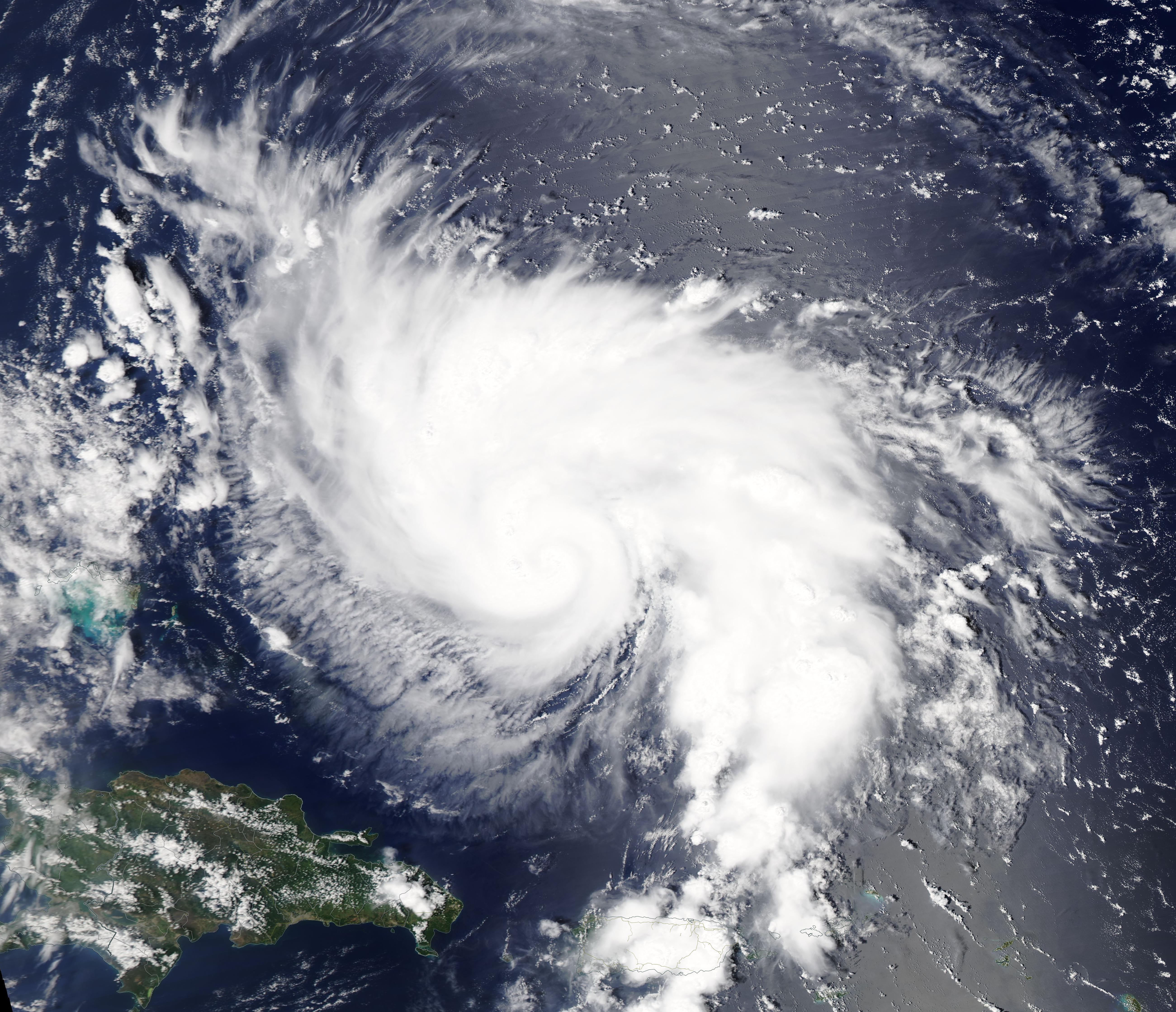 Satellite view of a large hurricane spiral over the Atlantic Ocean near Florida.