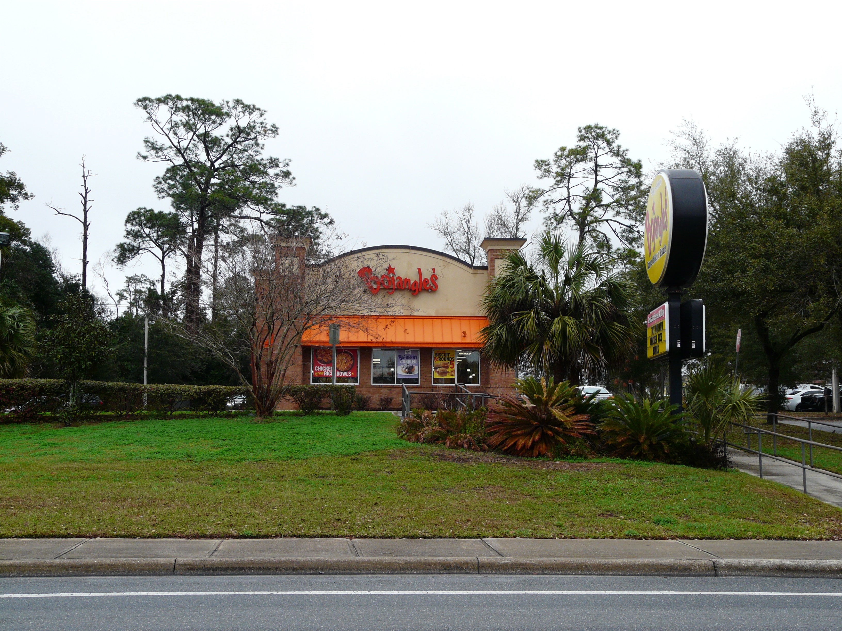 Bojangles restaurant exterior with orange brick facade and tall pole sign.