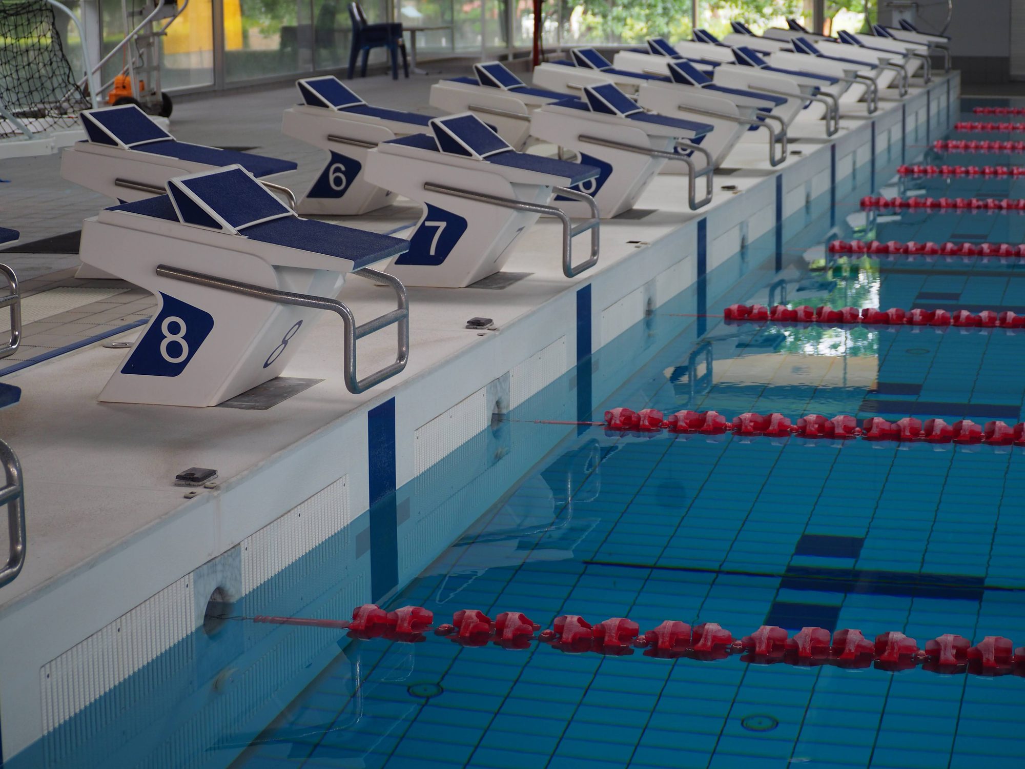 Starting blocks in a swimming pool with lanes. Image taken at AIS Training Centre