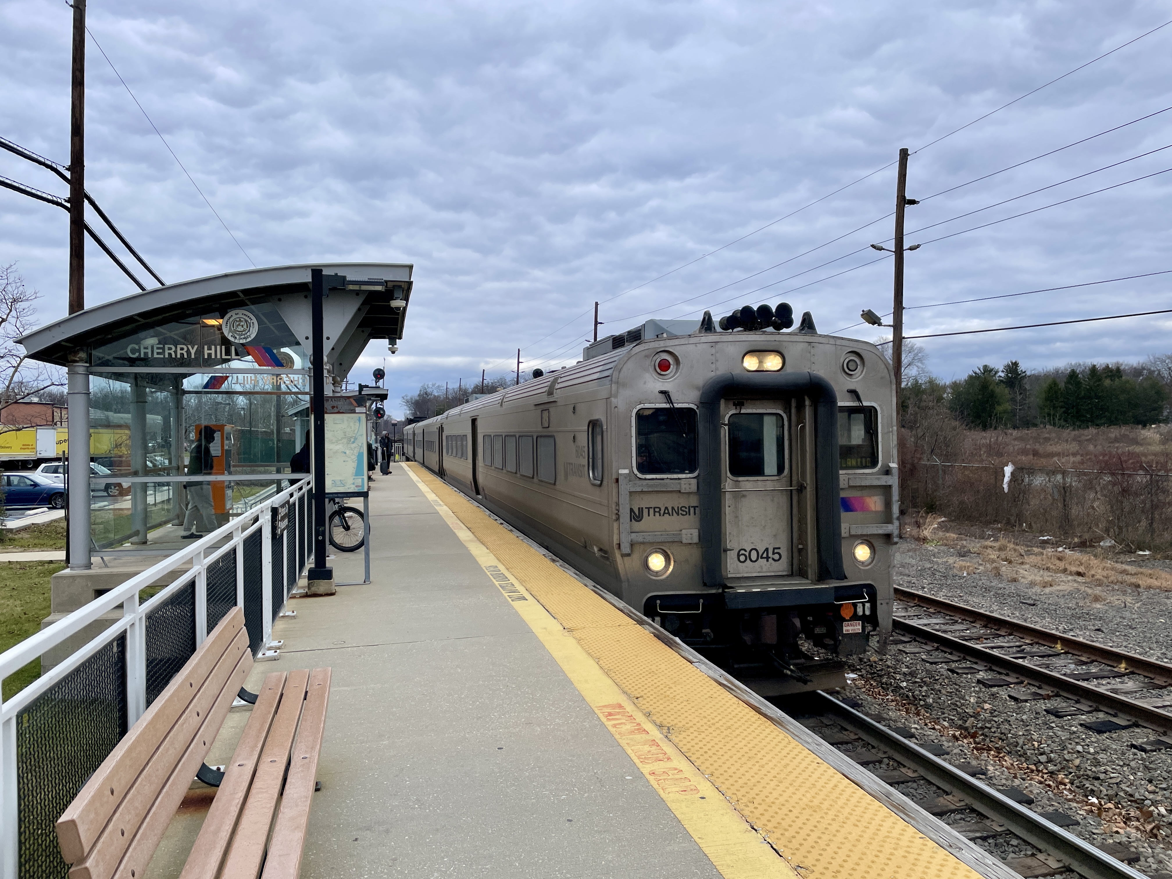 NJ Transit passenger train stopped at Cherry Hill station platform.