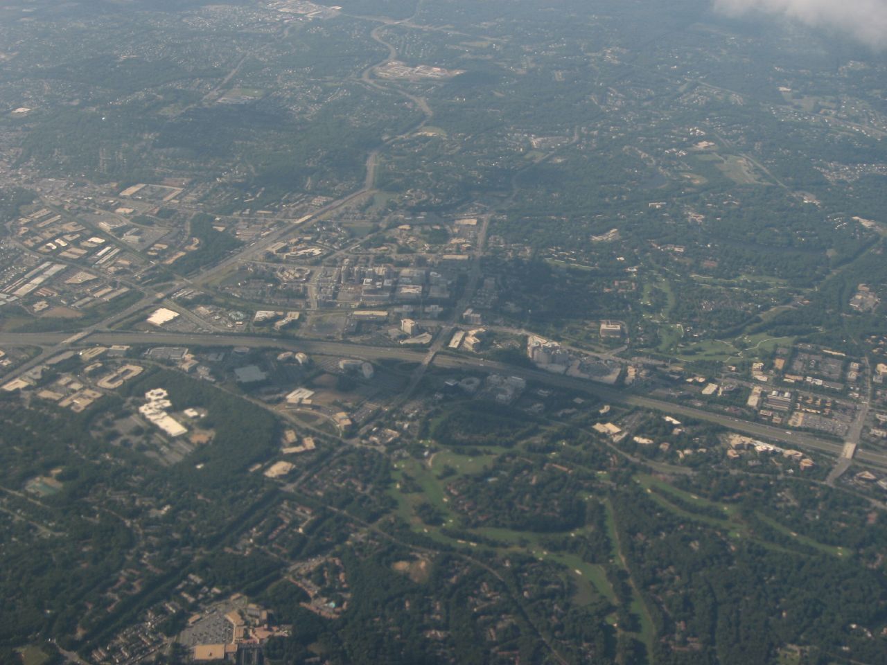 High-altitude aerial photograph of Reston, Virginia showing residential areas interspersed with green spaces and roadways.