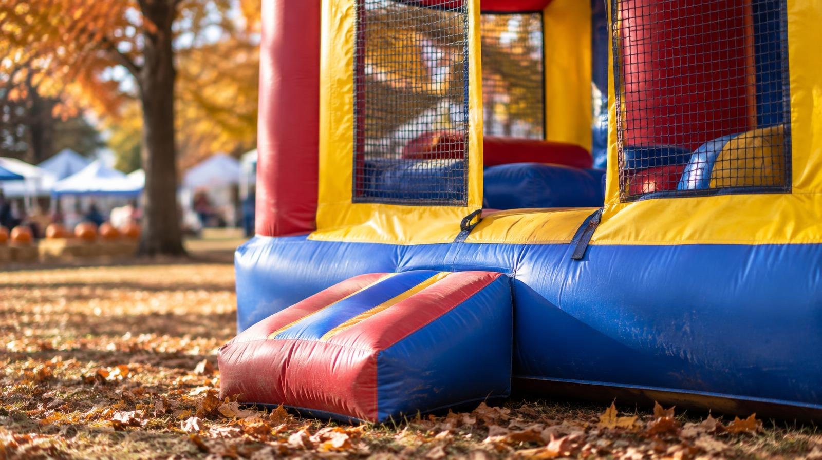 Colorful inflatable bounce house on a sunny fall day outdoors.