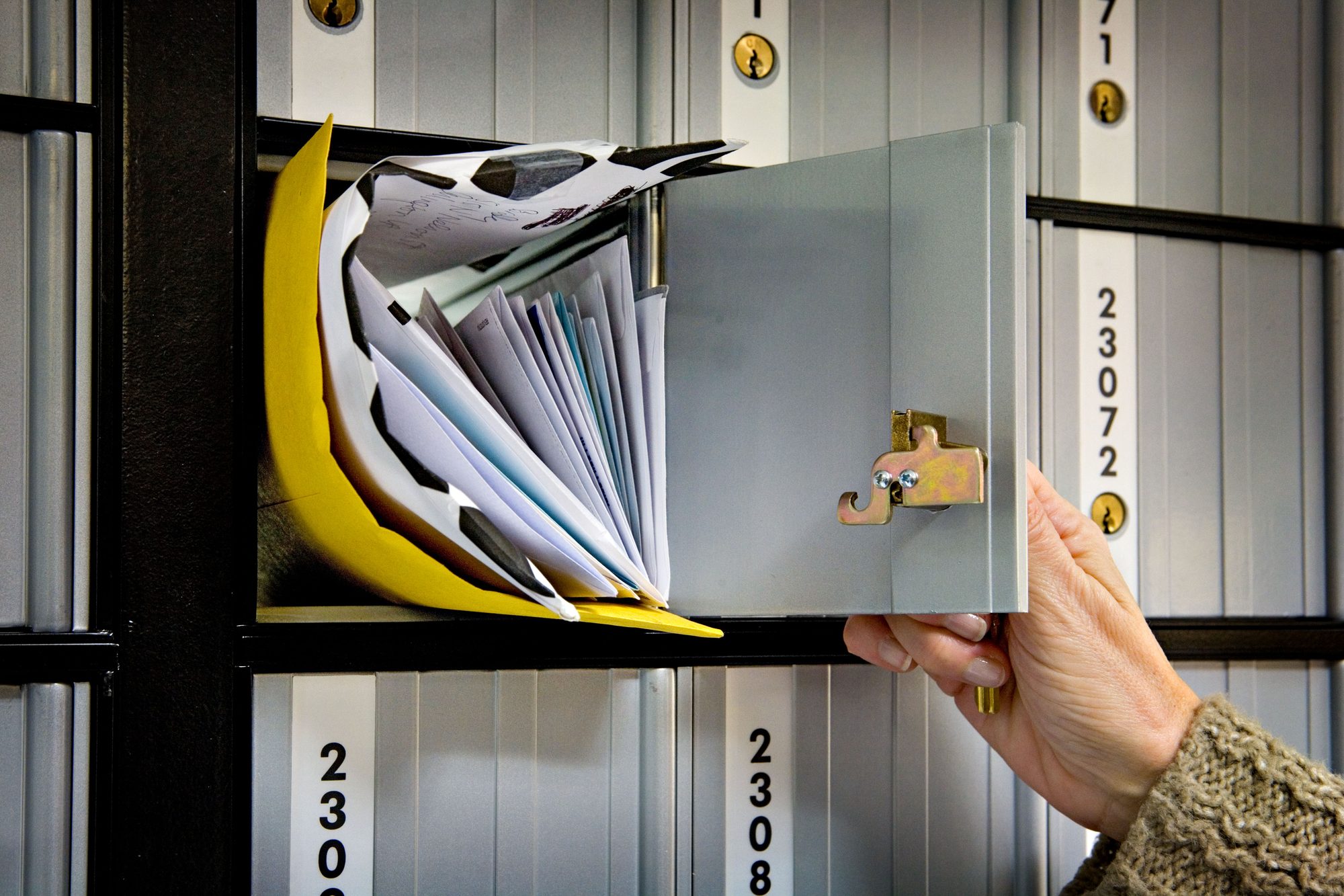 Letters in a post office box in a US post office lobby.