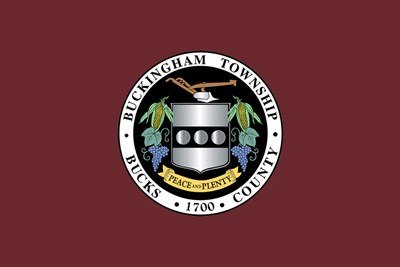 Official seal of Buckingham Township, Bucks County, Pennsylvania on a dark red background.