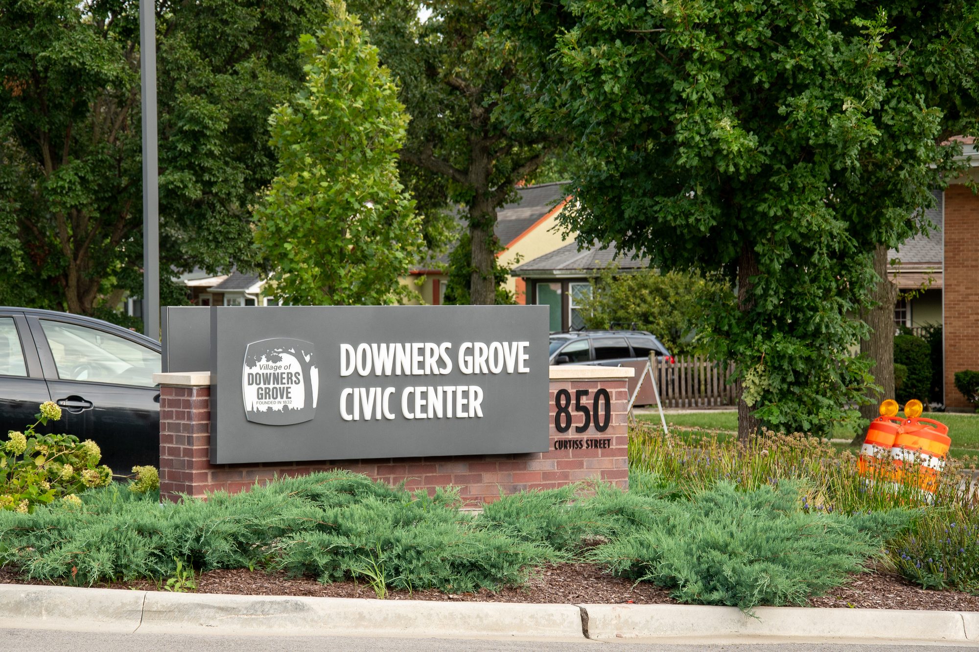 Monument sign reading Downers Grove Civic Center 850 beside landscaping.