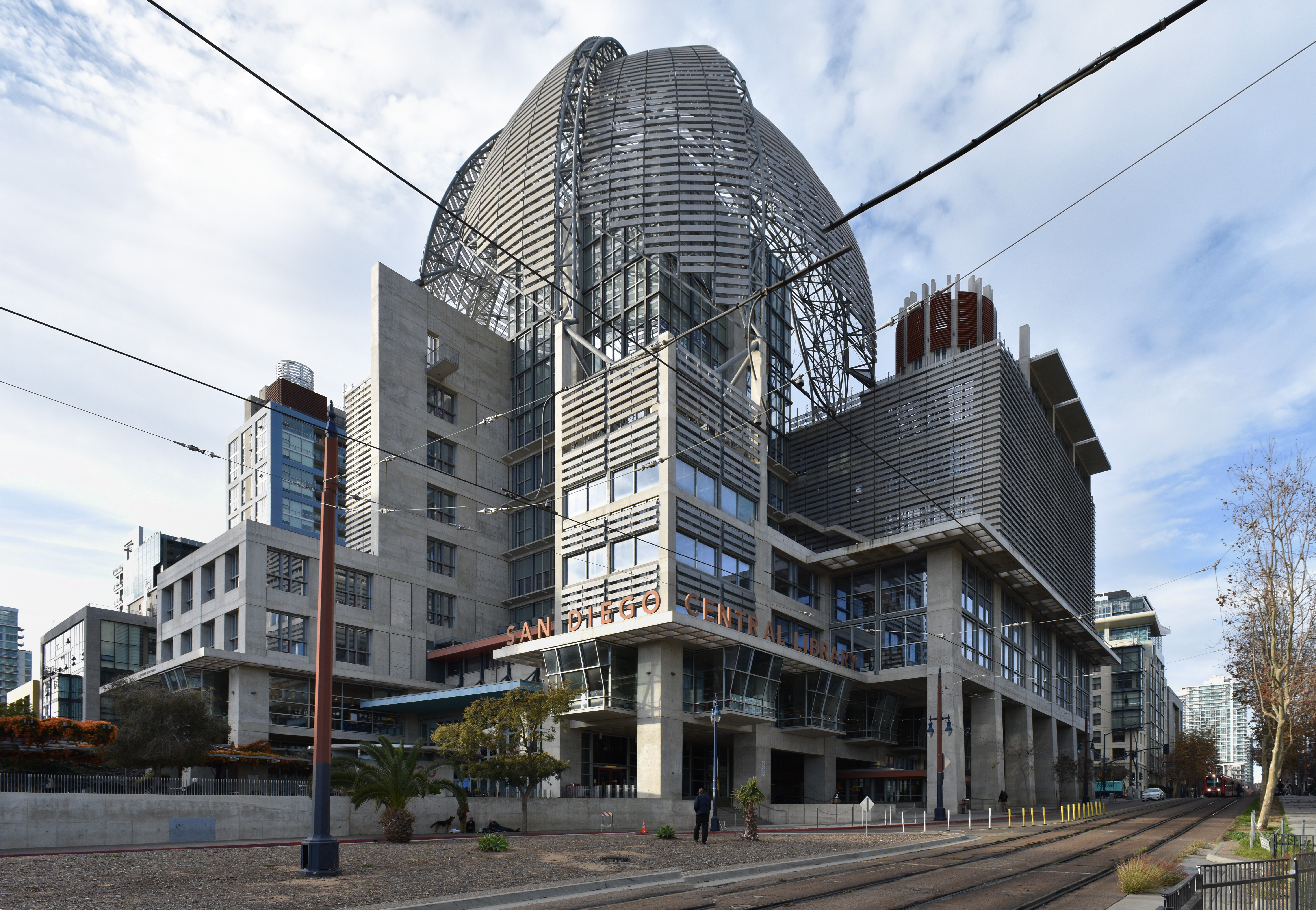 Exterior of a large modern library building with a metallic dome and visible entrance signage.