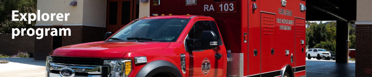 Red fire department rescue vehicle labeled RA 103 parked in a covered station bay.
