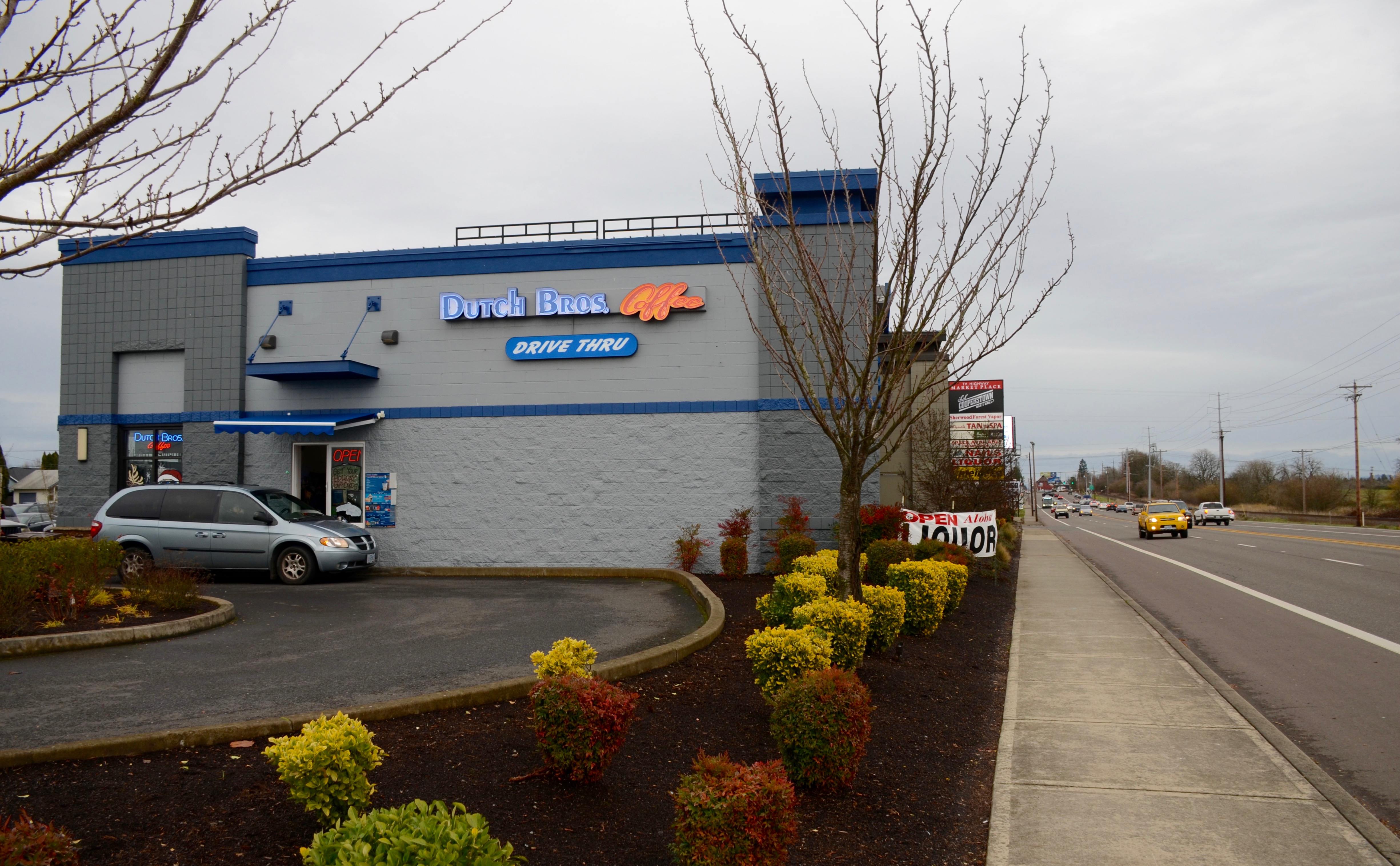 A Dutch Bros. Coffee drive-thru building with blue and white exterior and drive-thru signage.