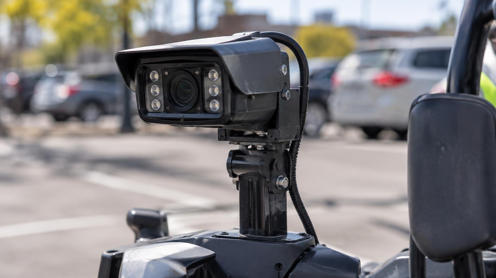 Close-up of a license plate reader camera mounted on a small scooter.