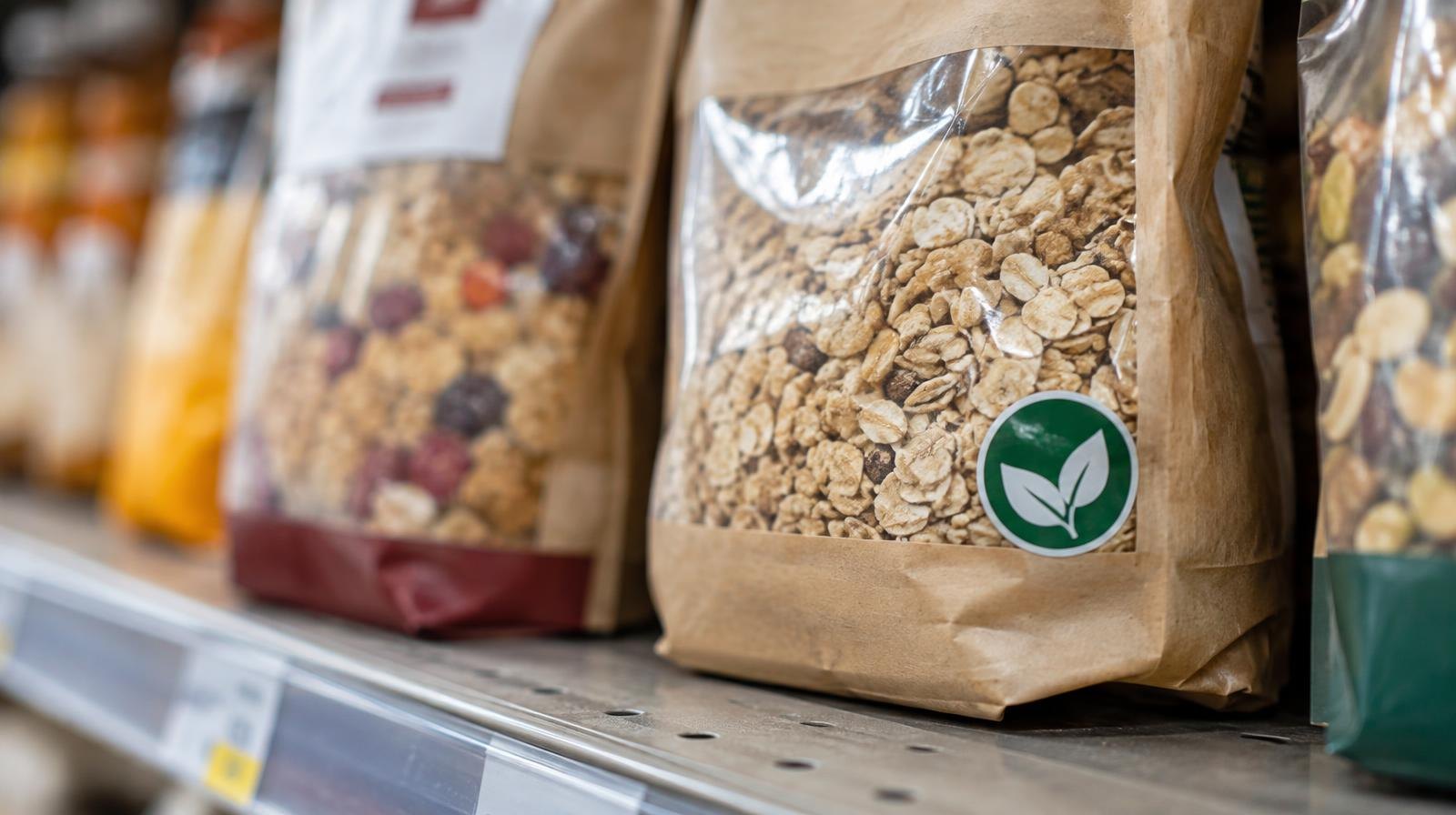 Packaged food products on a brightly lit grocery store shelf.