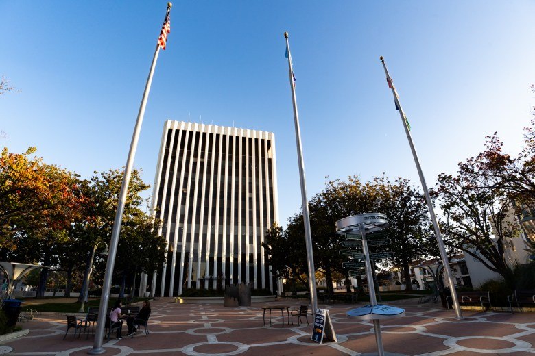 Palo Alto City Hall exterior with flagpoles and plaza on a clear day.