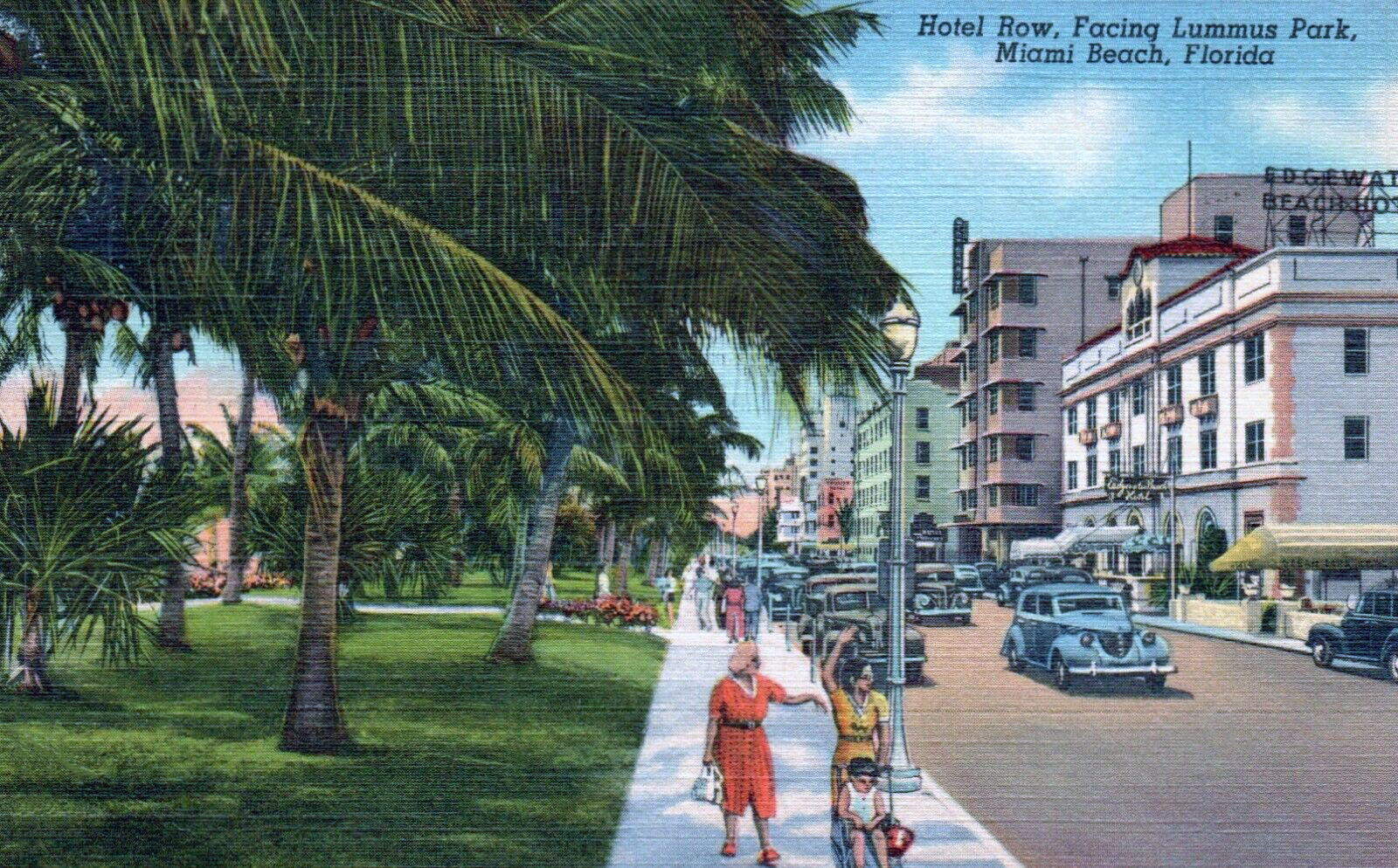 Colorized vintage postcard showing palm-lined hotel row with period automobiles.