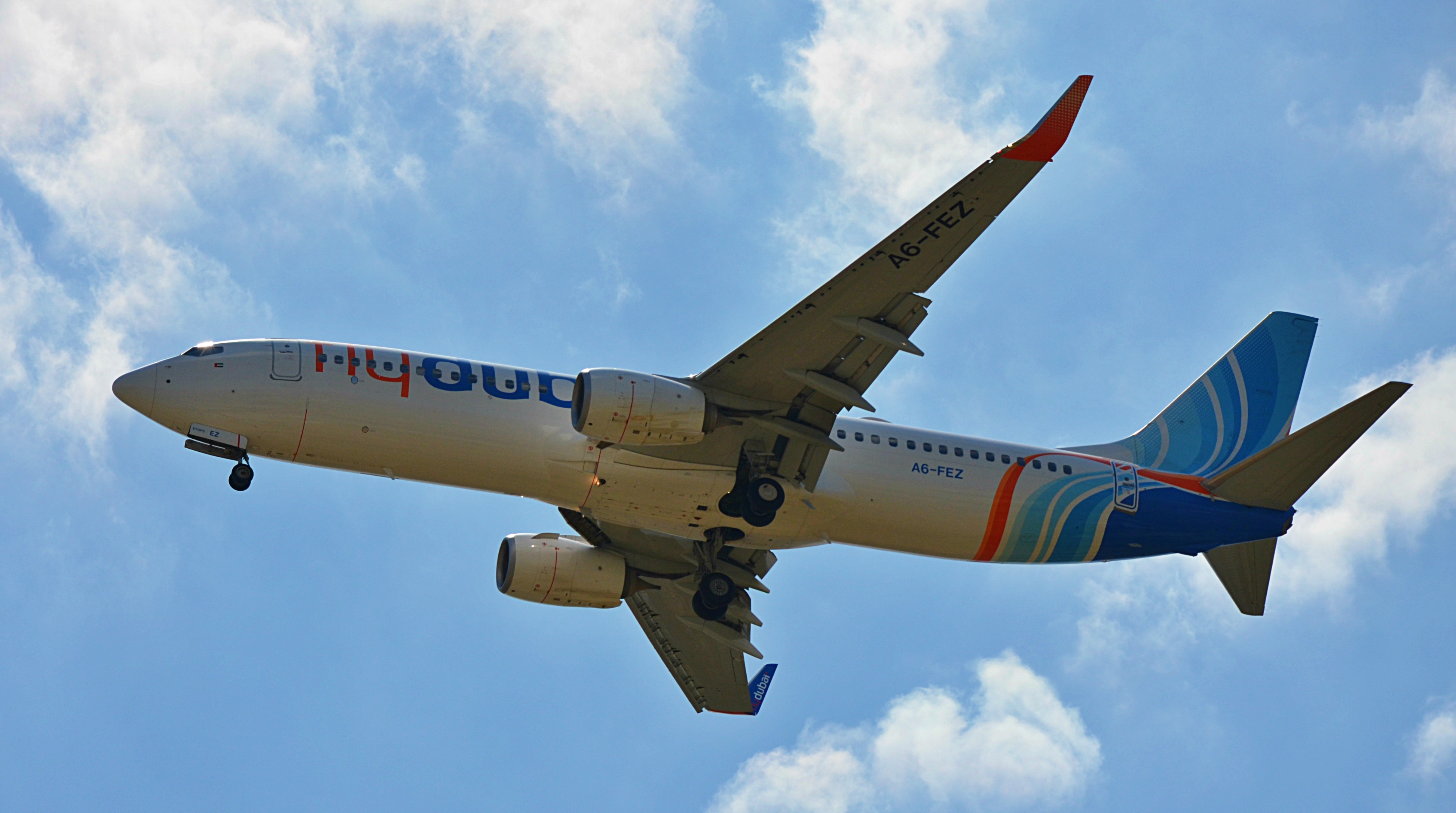 A Boeing 737-800 aircraft in flight against a clear blue sky.