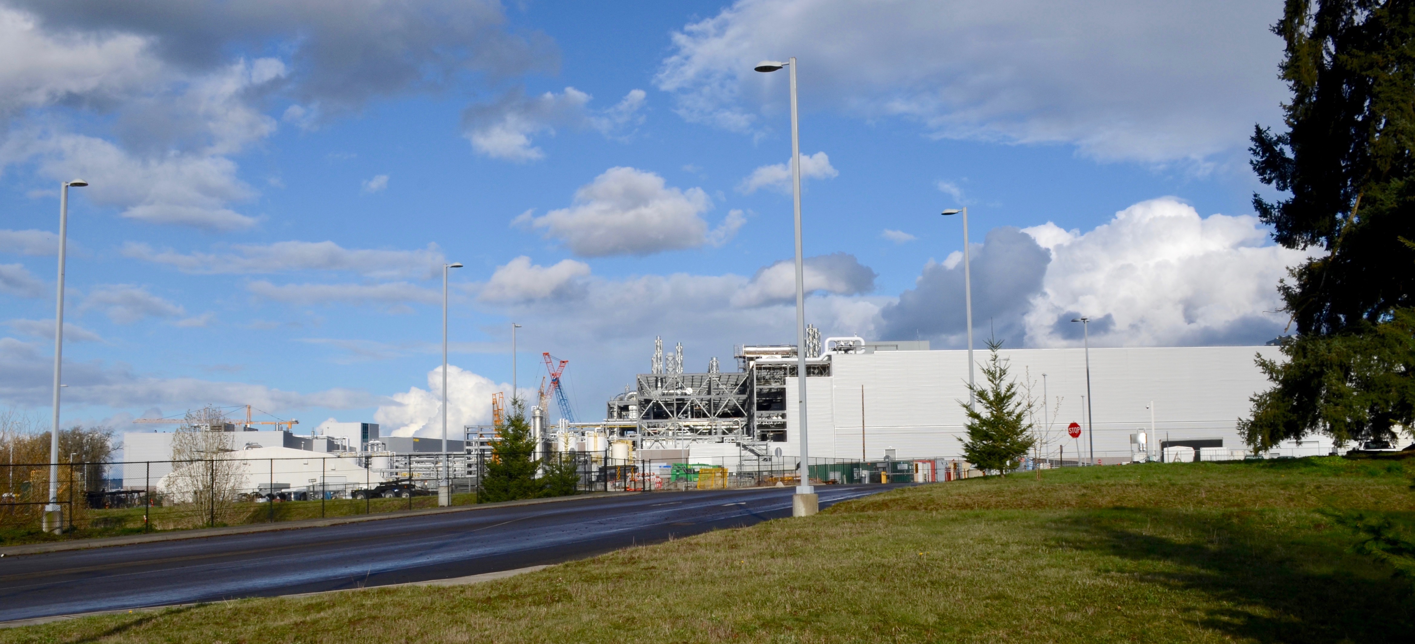 Large industrial production buildings at Intel's Ronler Acres campus with a curved road in the foreground.