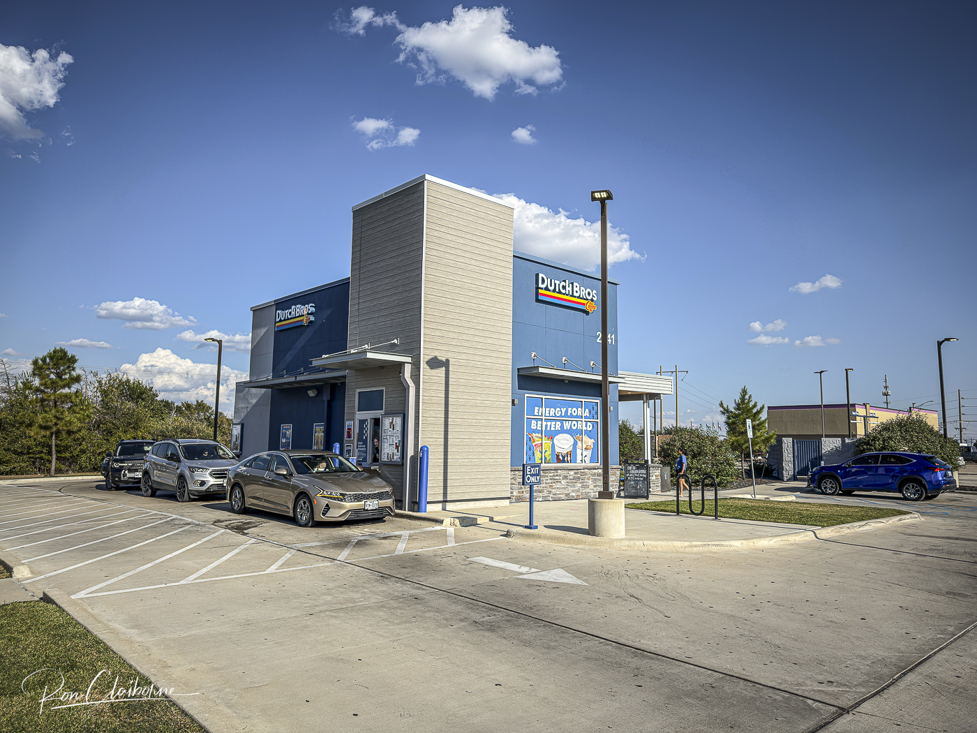 Dutch Bros Coffee drive-thru building with cars queued in the drive-thru lane.