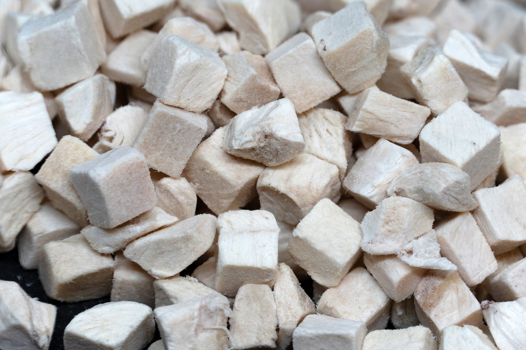 Close-up shot of freeze-dried chicken breast pieces, ready for a quick snack.