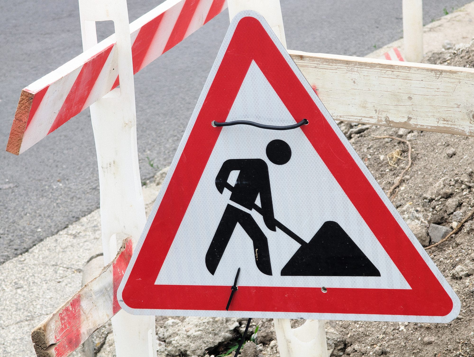 Road work ahead sign warns people about active construction zone