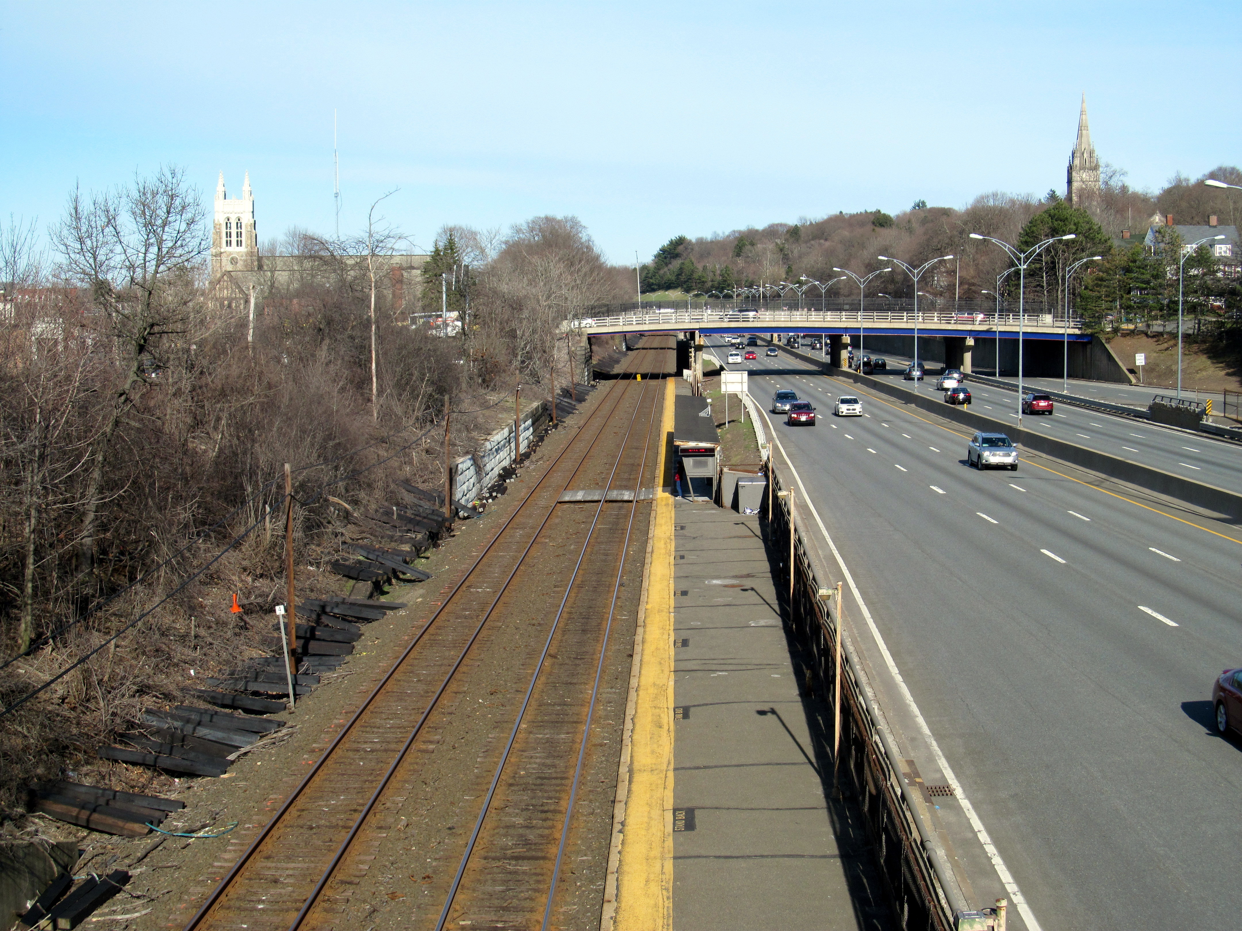 Commuter rail station building viewed from a street rotary on a cloudy day.
