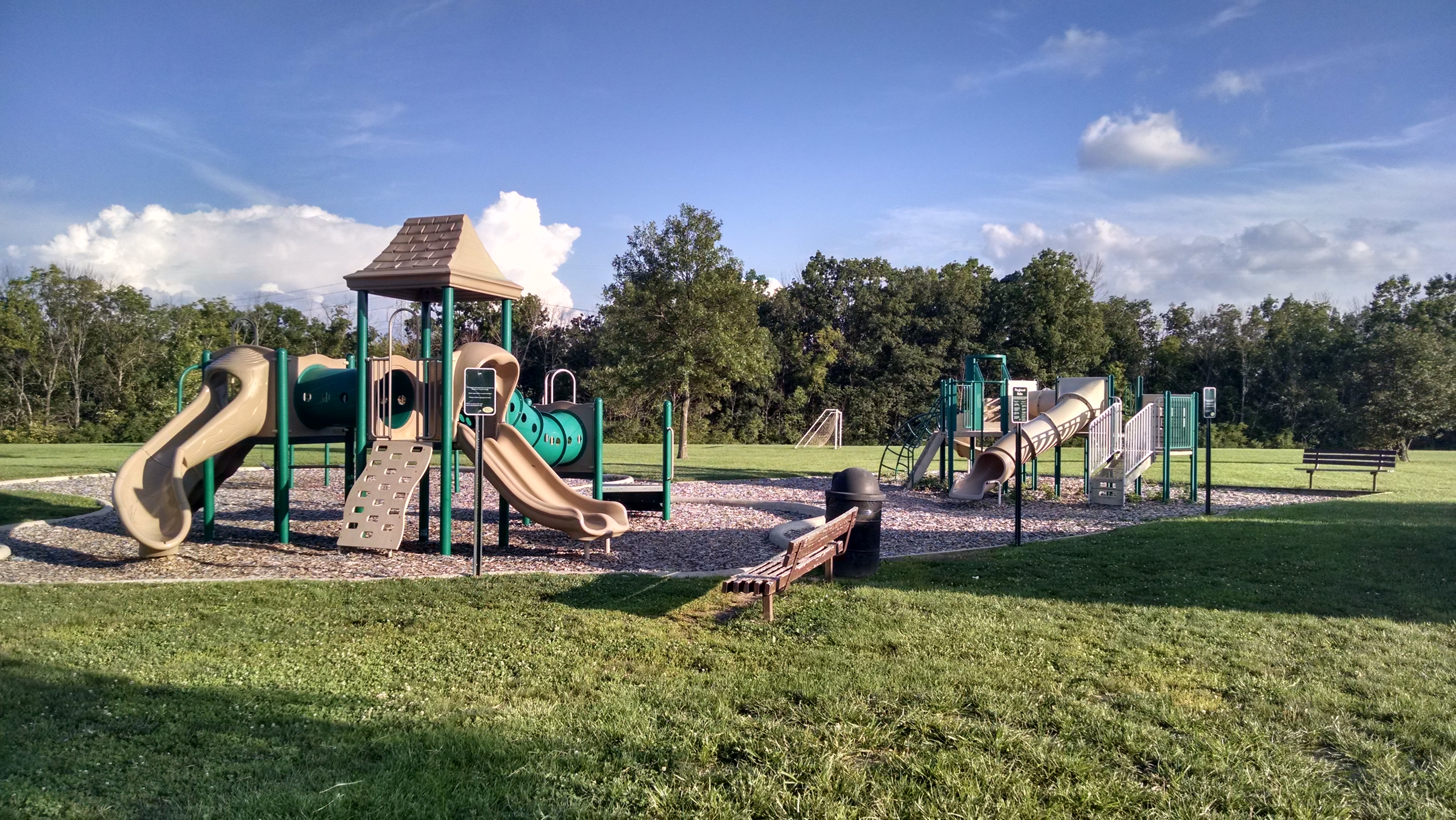 Colorful playground with slides and climbing structures at a West Chester, Ohio park.