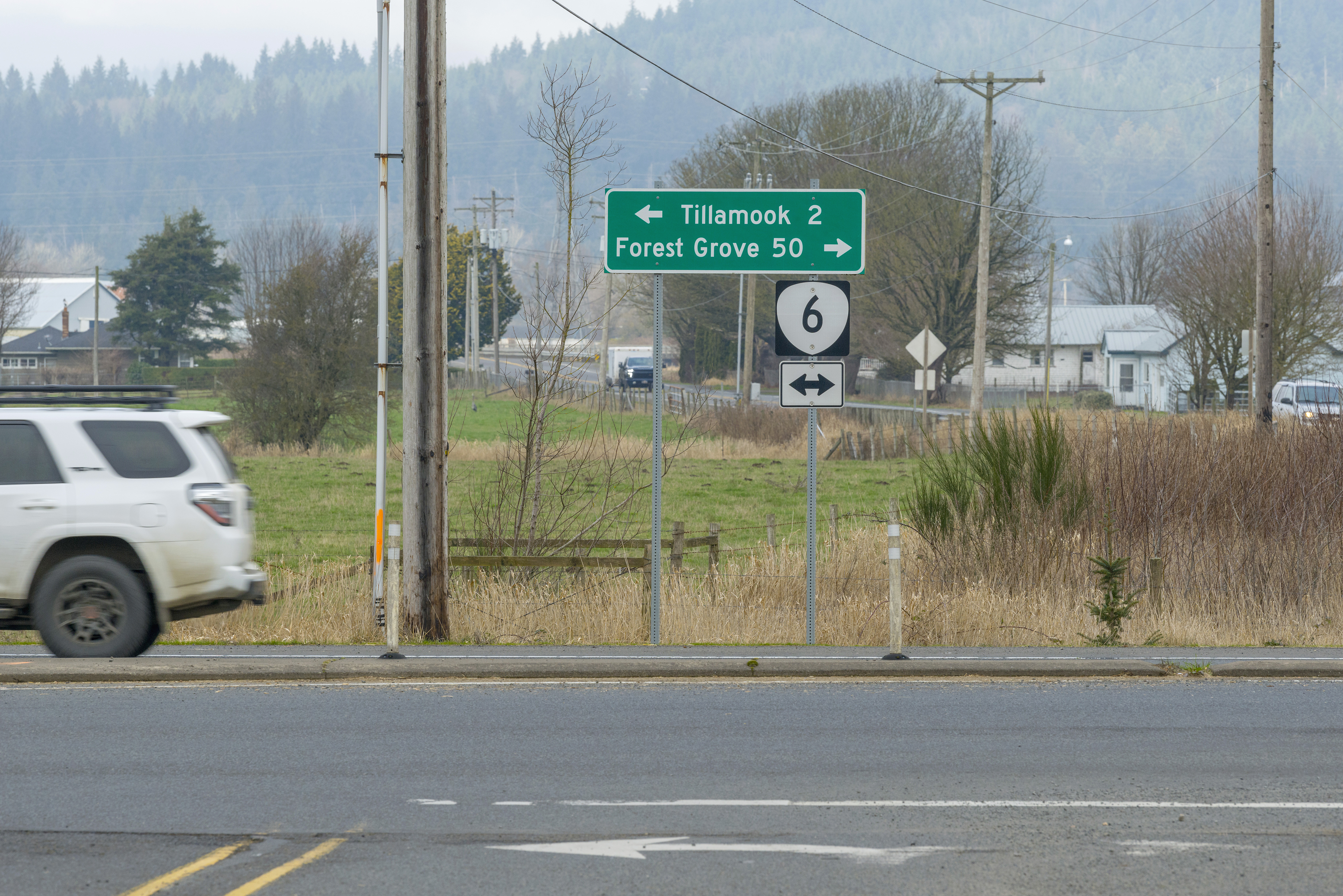 Green highway sign showing distances to Tillamook and Forest Grove along Oregon Route 6.