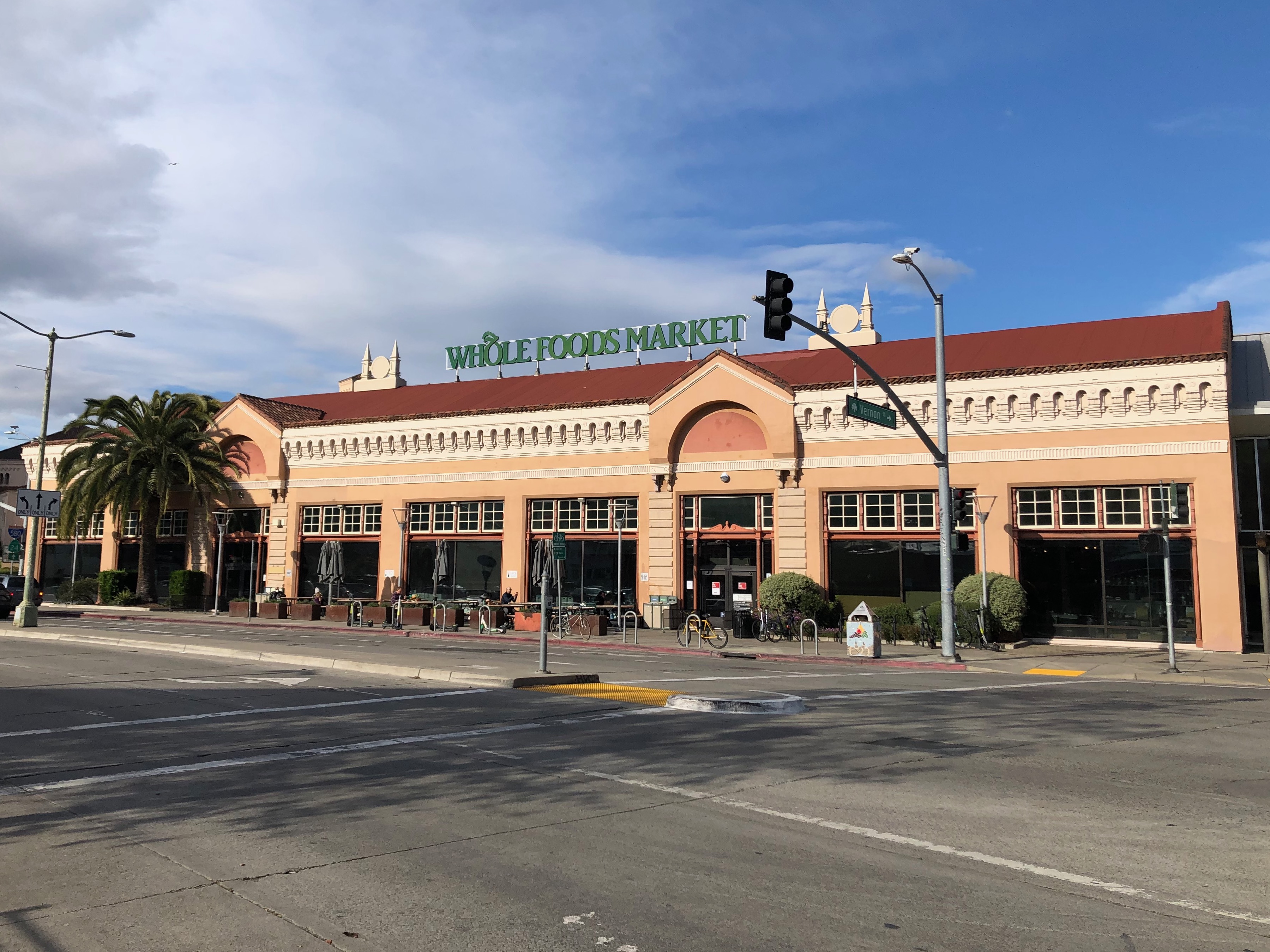 Whole Foods Market store in a large corner building with green signage.