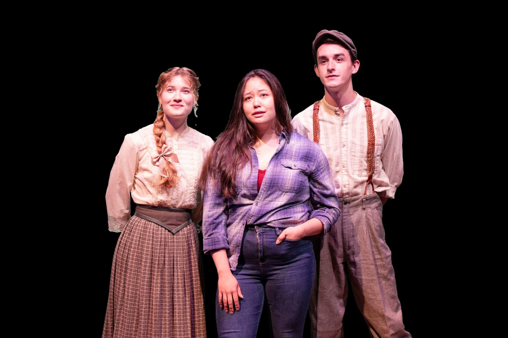 Three performers in period and modern costumes pose against a black background.