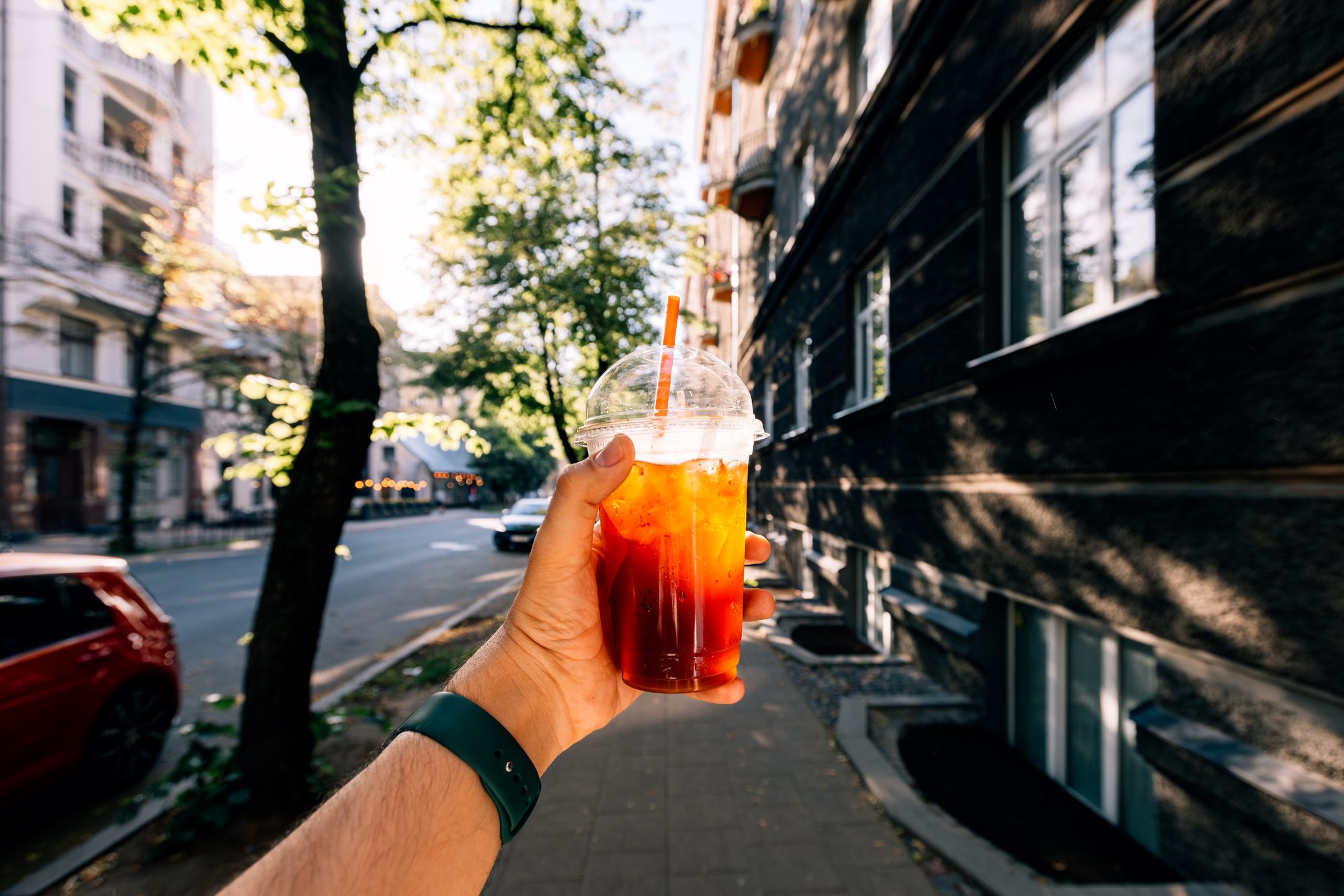 Drinking iced coffee on a sunny summer day, personal perspective view