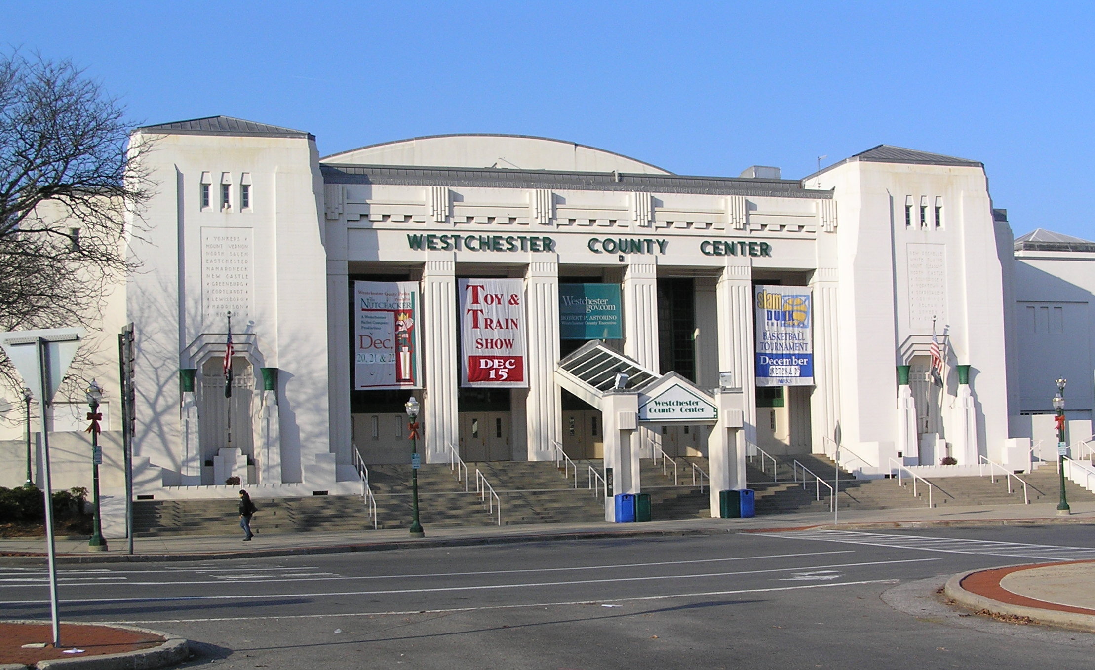 Art Deco exterior facade of the Westchester County Center with entrance steps and American flag.