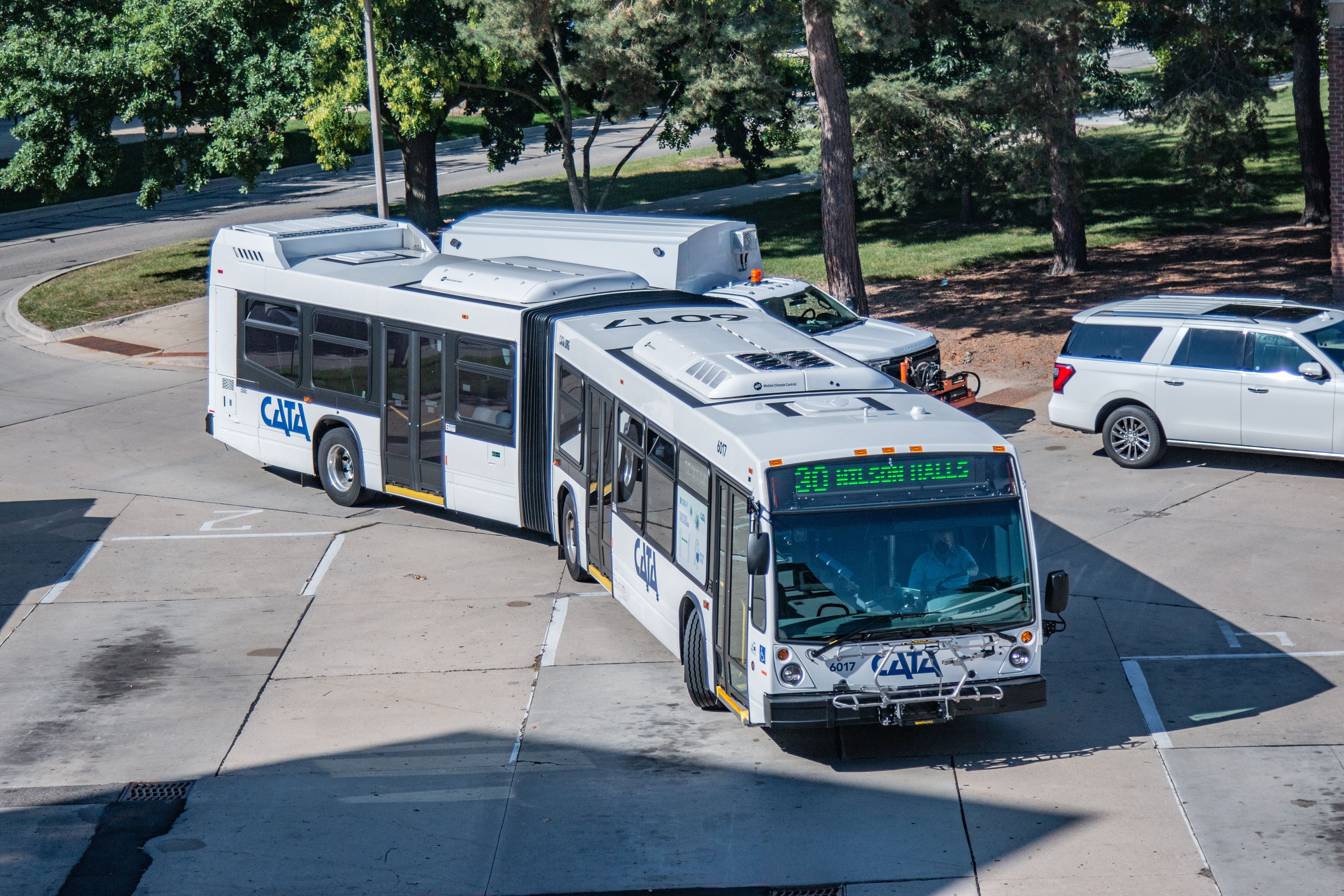 An articulated CATA bus rounds a transit center loop on an overcast day.