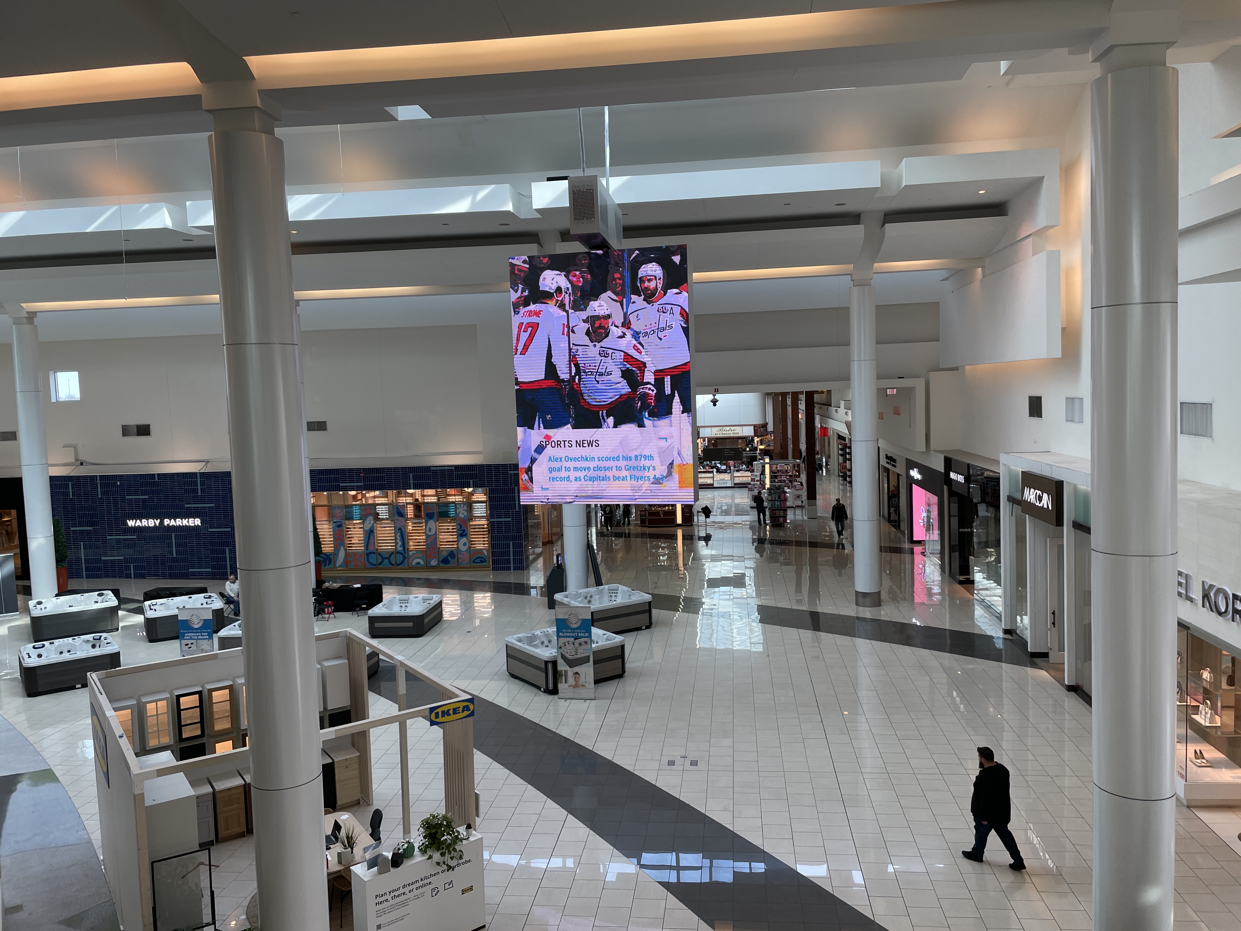 Interior grand court of a large shopping mall viewed from the second floor.