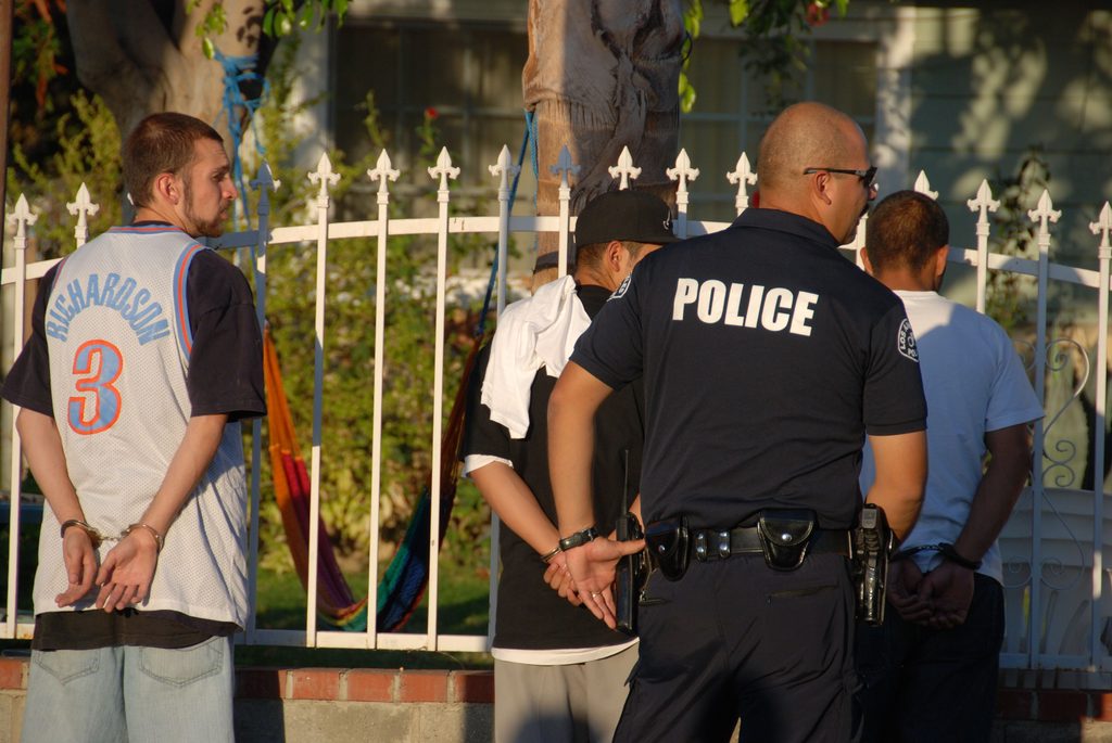 LAPD officer arresting suspected gang members.