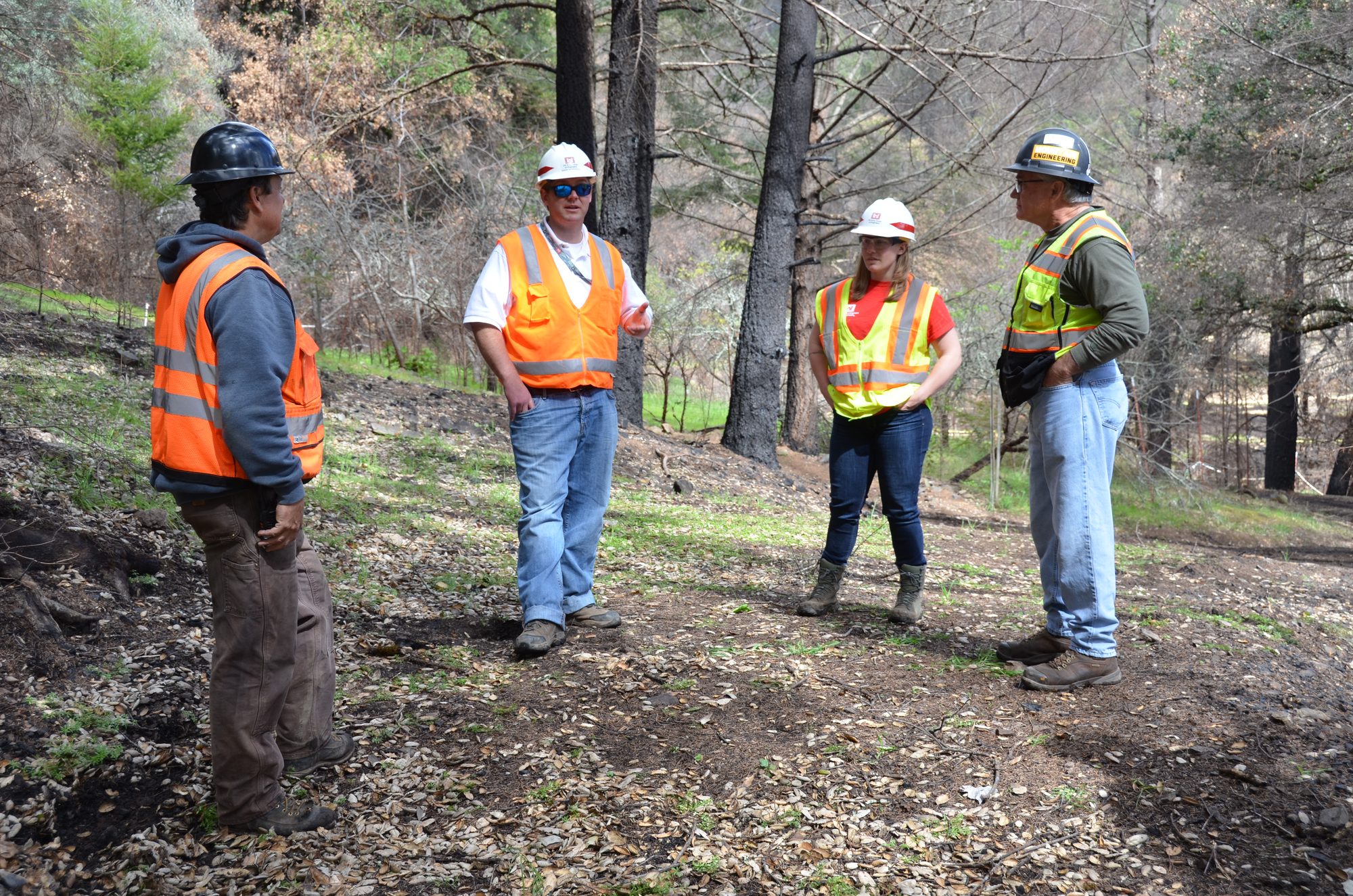 USACE Area Engineer Mark Swenson and Resident Engineer Emily Hammond discuss access to a debris removal site with contractors. The Corps, under the direction of the Federal Emergency Management Agency and in partnership with the California Governor’s Office of Emergency Services, is removing ash and fire-related debris in Northern California following the October 2017 wildfires.   (Photo by Mike DeRusha)