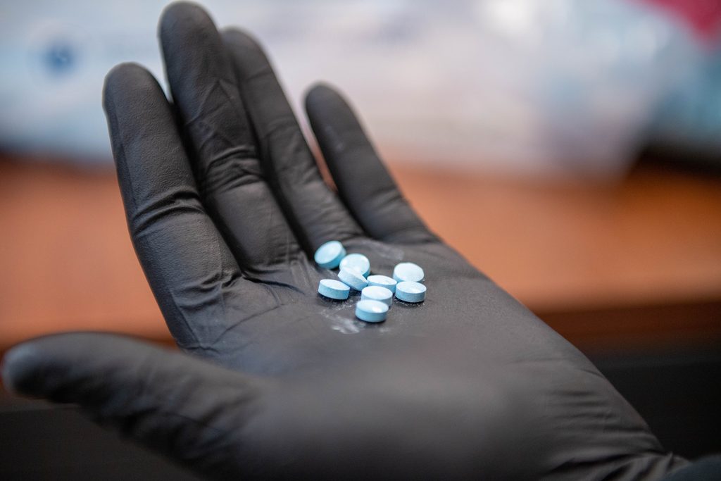 An HSI special agent displays synthetic fentanyl pills.