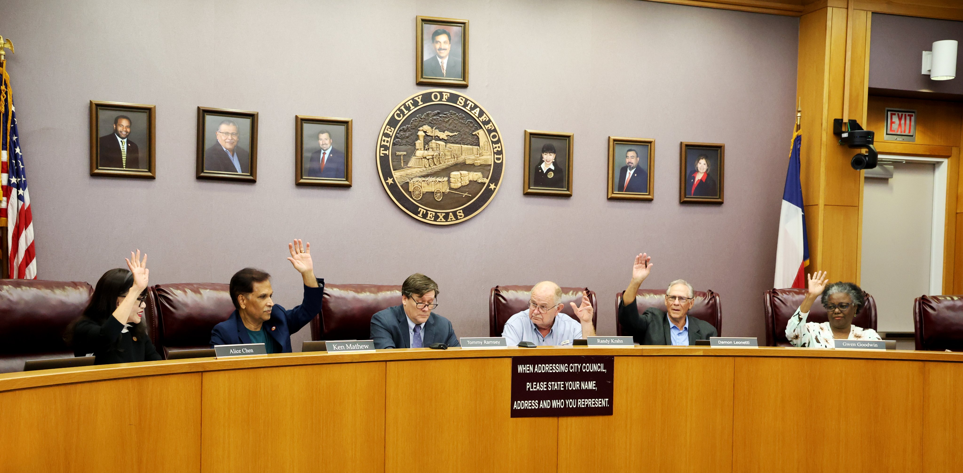 City of Stafford TX EDC Board raising hands during meeting at town building.