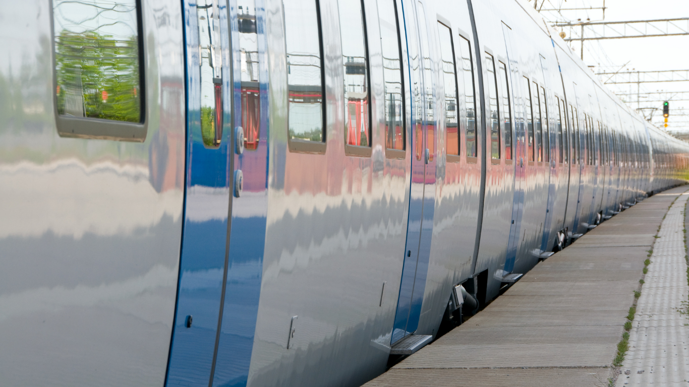 Commuter train pulls up to station for travelers.