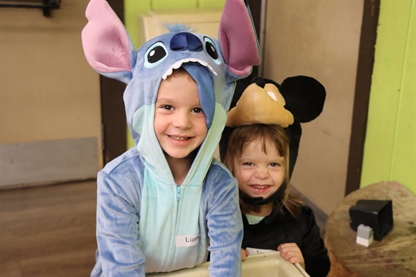 Two kids dressed up as Disney characters