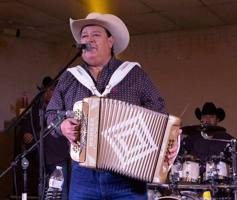 Man singing and playing on the accordian.