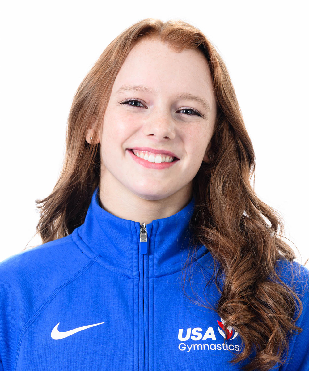 Girl posing smiling for headshot.